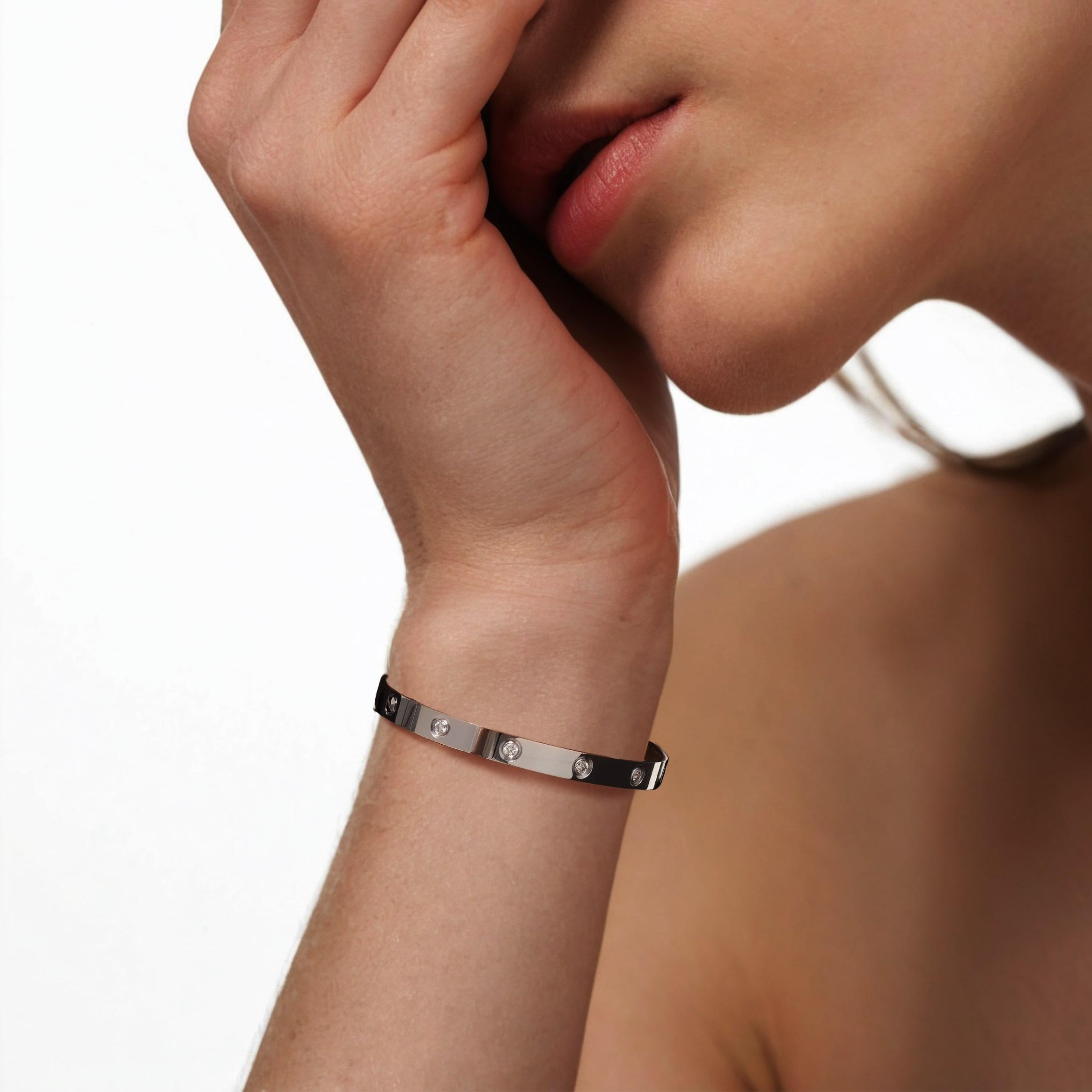 The Cartier Love 18K White Gold Diamond Bracelet is a sleek, unisex bangle that merges Cartier’s minimalist screw motif with elegant diamond accents, secured by a symbolic screw-lock mechanism. It comes in multiple sizes and counts of diamonds,
