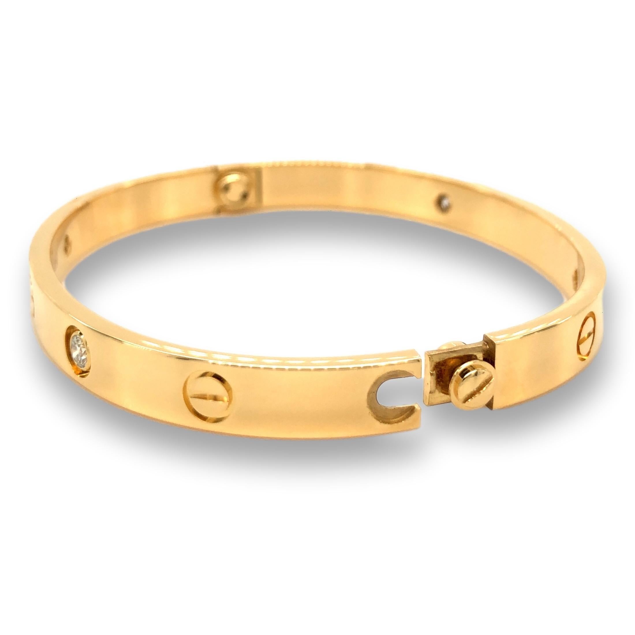 Cartier bangle bracelet from the iconic Love collection finely crafted in 18 karat yellow gold featuring 4 round brilliant cut diamonds weighing 0.42 cts. total weight in a size 17.  Bracelet is fully hallmarked and includes original
