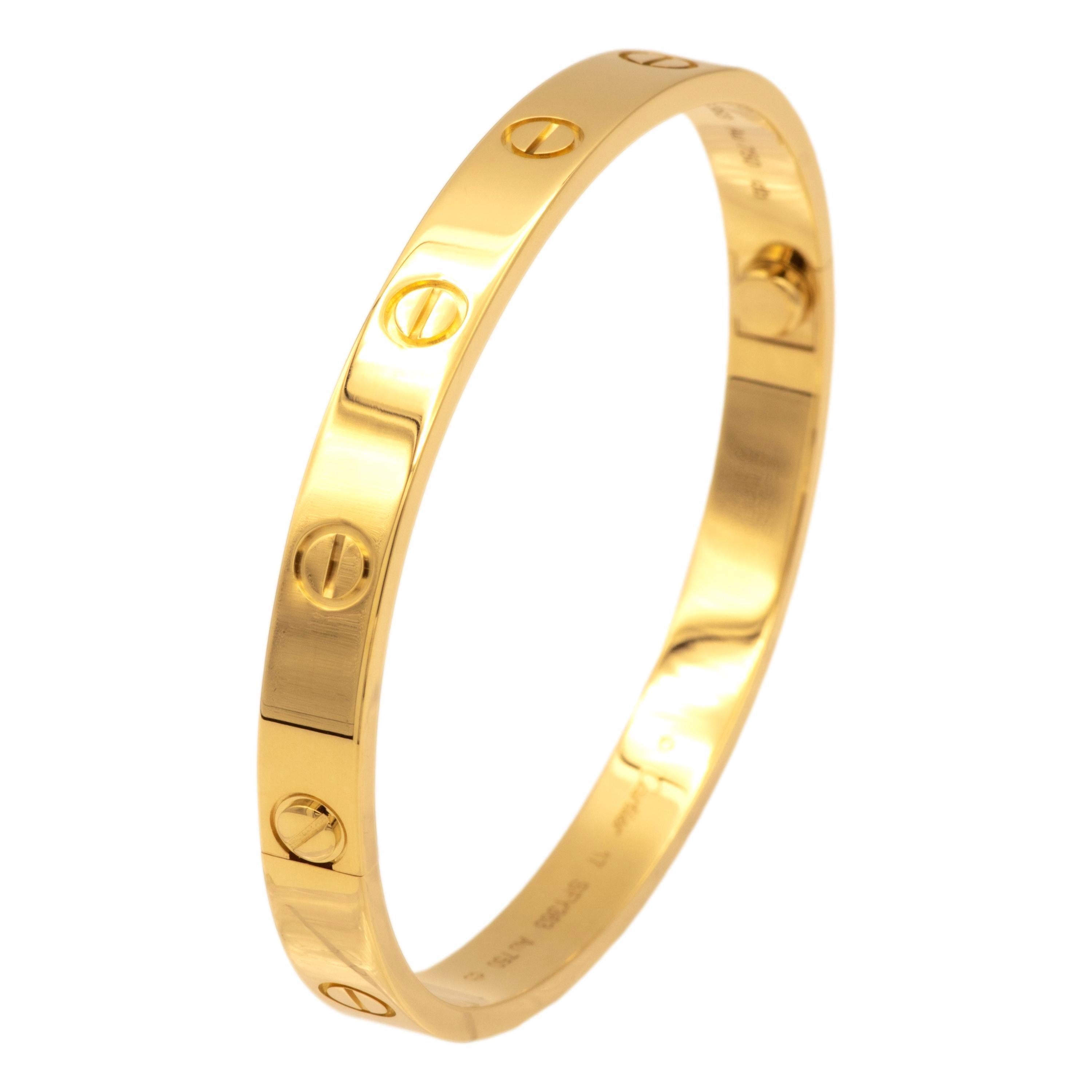 Cartier bangle bracelet from the iconic Love collection finely crafted in 18 karat yellow gold featuring screw motifs all the way around in a size 17. The closure is designed with two screws placed on either side of the bracelet. Bracelet is fully