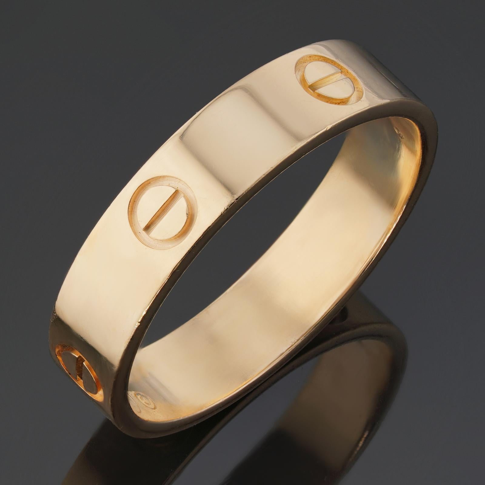 This authentic unisex Cartier ring from the iconic Love collection is crafted in 18k yellow gold and accented with trademark screw-shaped circles. Made in France circa 2010s. Measurements: 0.19
