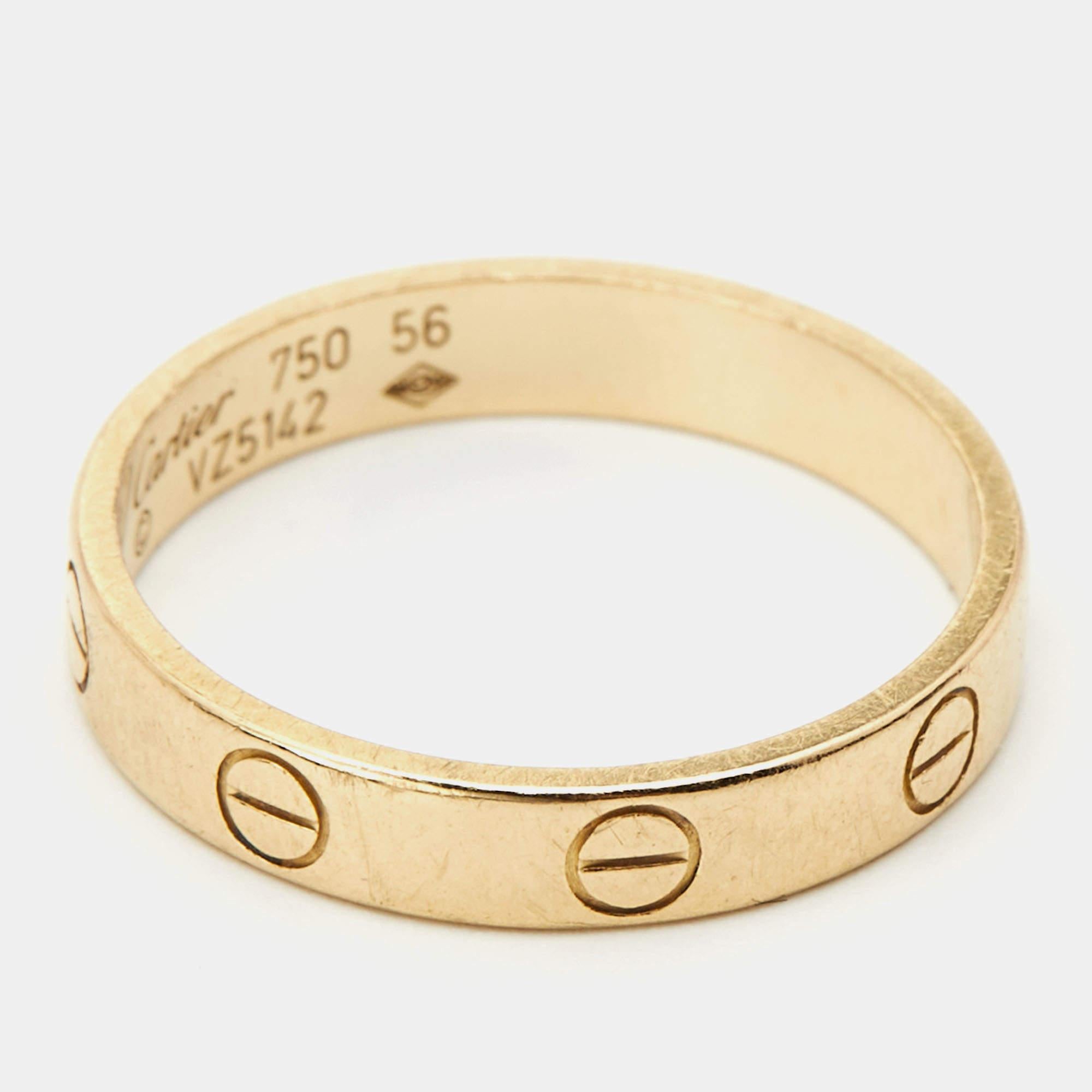 One of the most iconic and loved designs from the house of Cartier, this stunning Band ring is an icon of style and luxury. Constructed in 18K yellow gold, this ring features screw details all around the surface as symbols of a sealed and secured