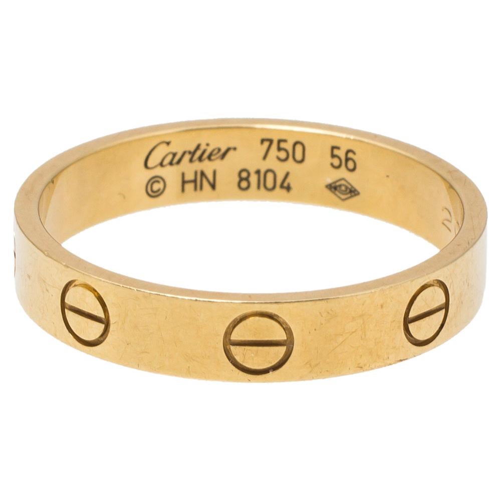 One of the most iconic designs from the house of Cartier, this stunning Love ring is an icon of style and luxury. Constructed in 18K yellow gold, this ring features screw details all around the surface as symbols of a sealed and secured bond. This