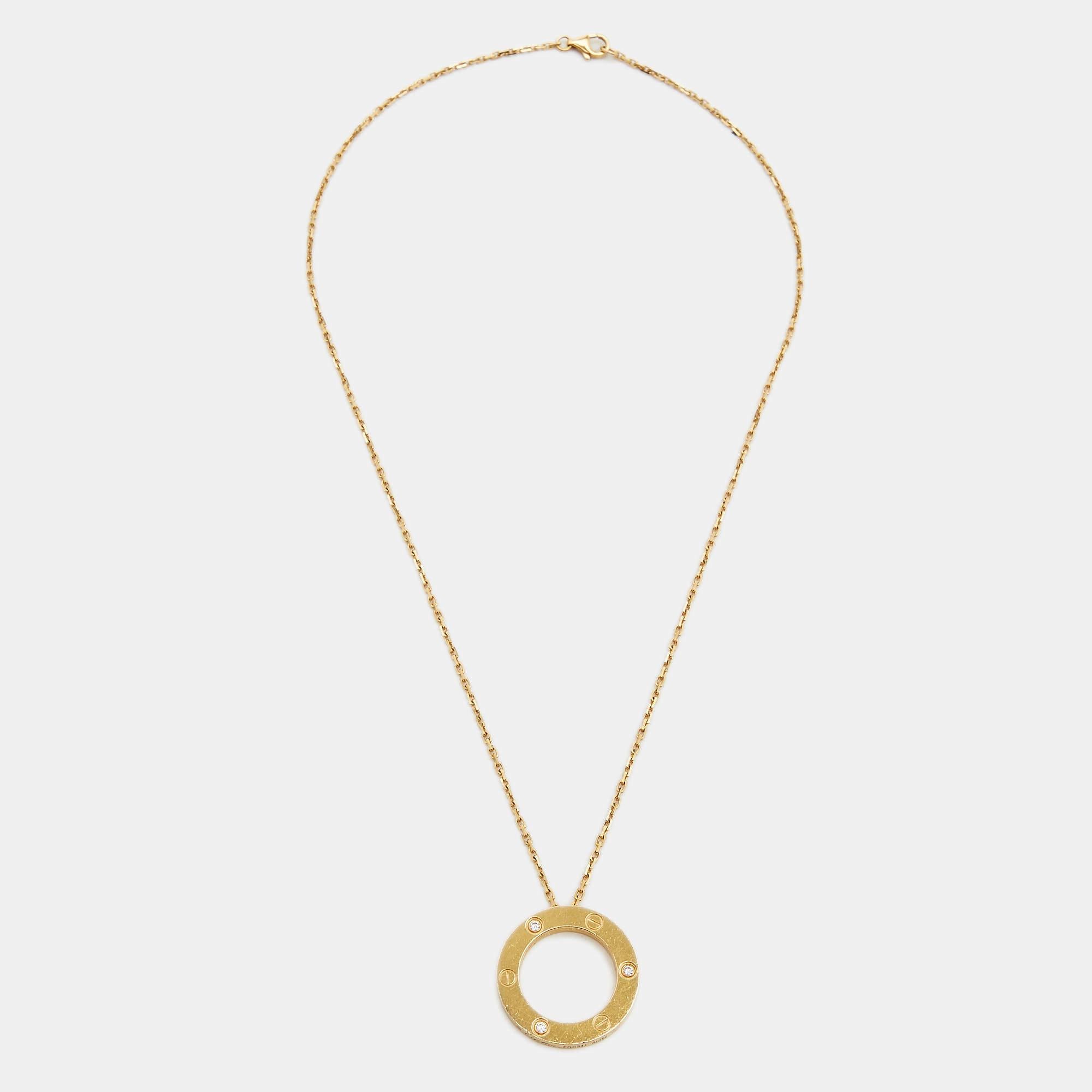 This radiant Love necklace from Cartier is not only beautiful to look at but also a timeless piece that will be cherished for years to come! It has been crafted from 18K yellow gold and features a chain-link carrying a ring pendant that is detailed
