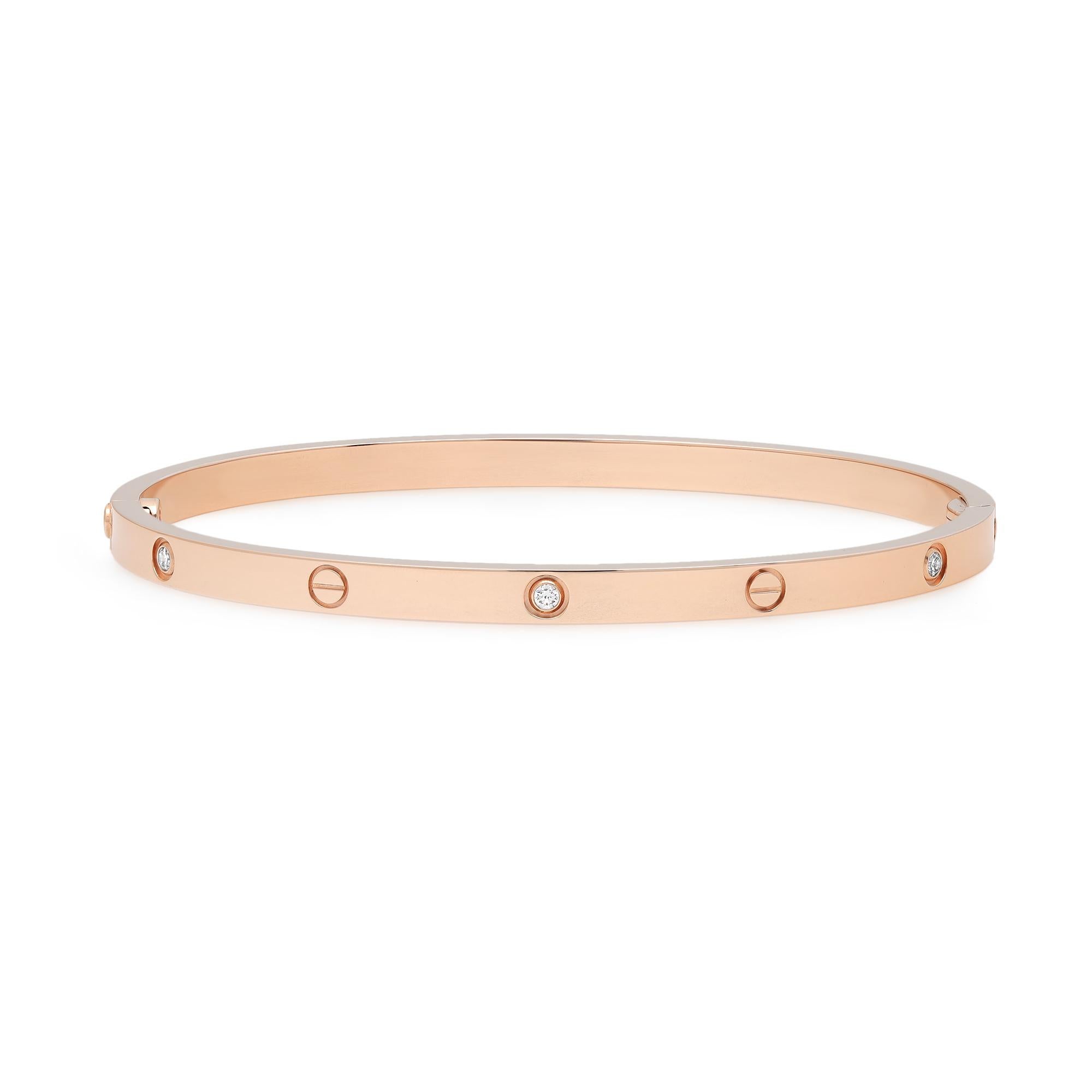 Cartier LOVE bracelet small model. Crafted in 18k rose gold, set with 6 round brilliant cut diamonds weighing 0.15 carat. A close fitting, oval bracelet composed of two rigid arcs which are worn on the wrist and removed using a specific screwdriver.