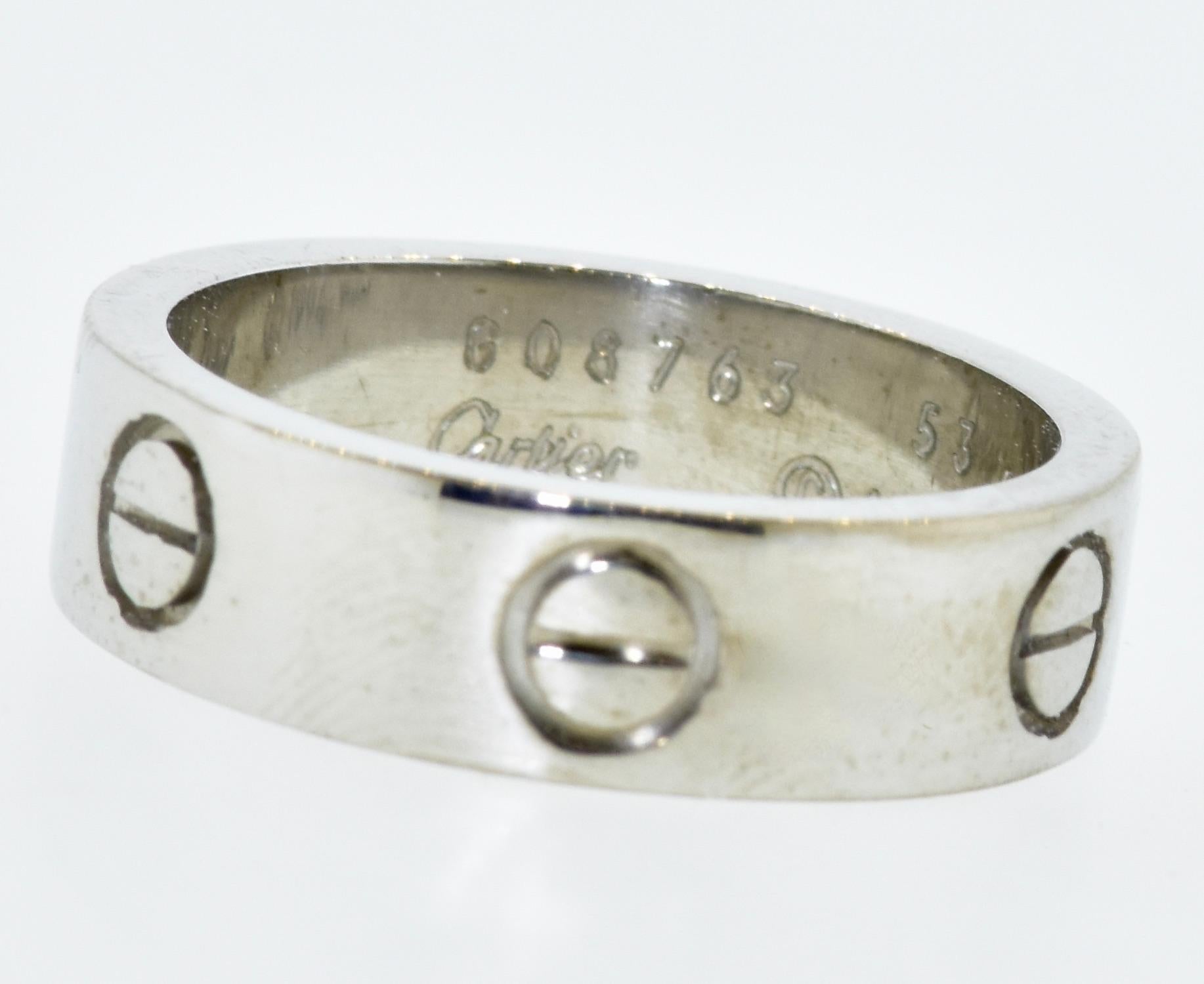 Cartier LOVE band ring in 18K white gold.  In excellent condition, this band is signed, numbered, dated, 1996, the European size, and 750 for 18K white gold.  This band is a size 6.5 American, (this ring would be very difficult to resize), and