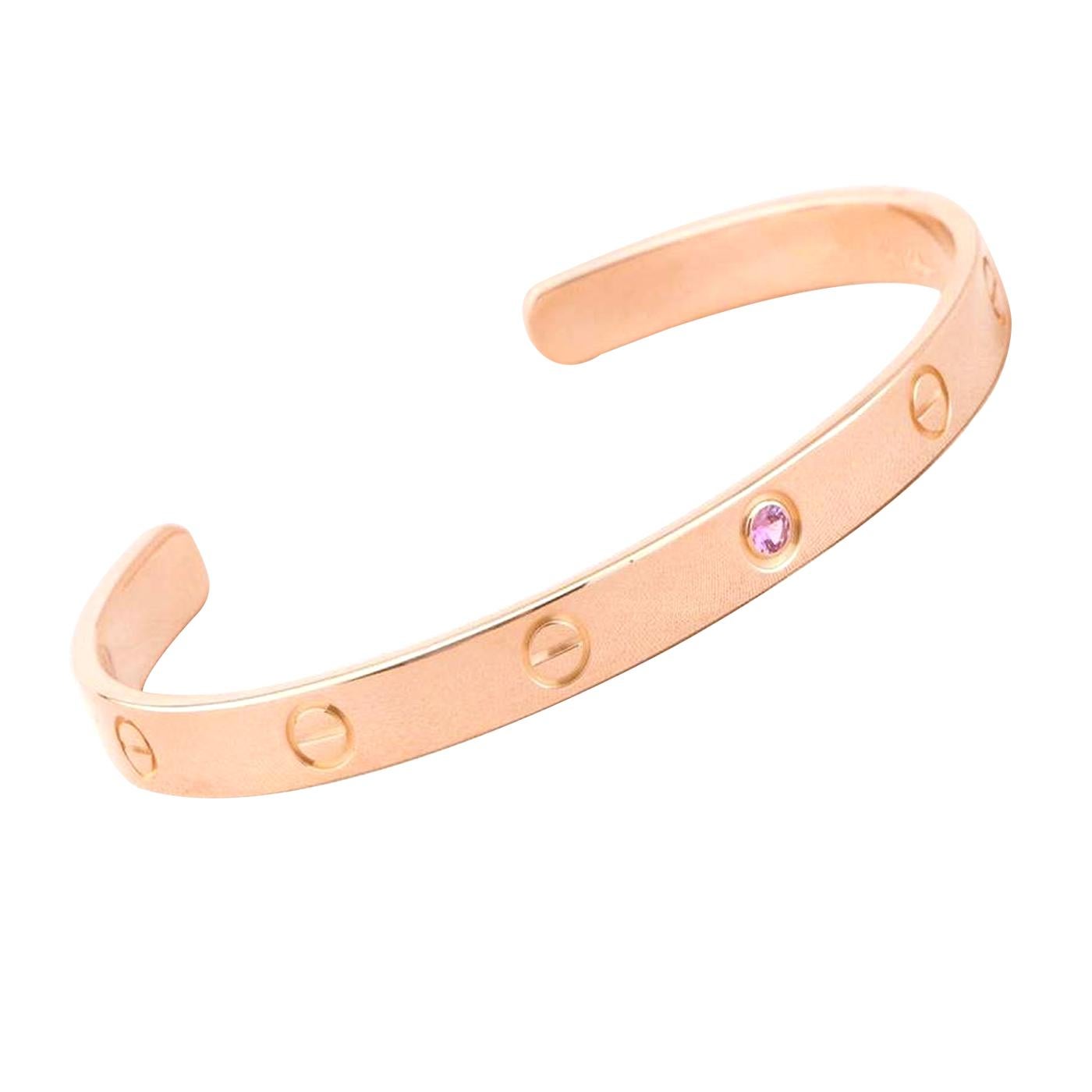 Cartier's Love bracelet is a modern symbol of luxury and a way to lock in one's love. Designed in an oval shape to comfortably sit around your wrist, the iconic love handcuff is laid with distinct screw motifs and secured by screw