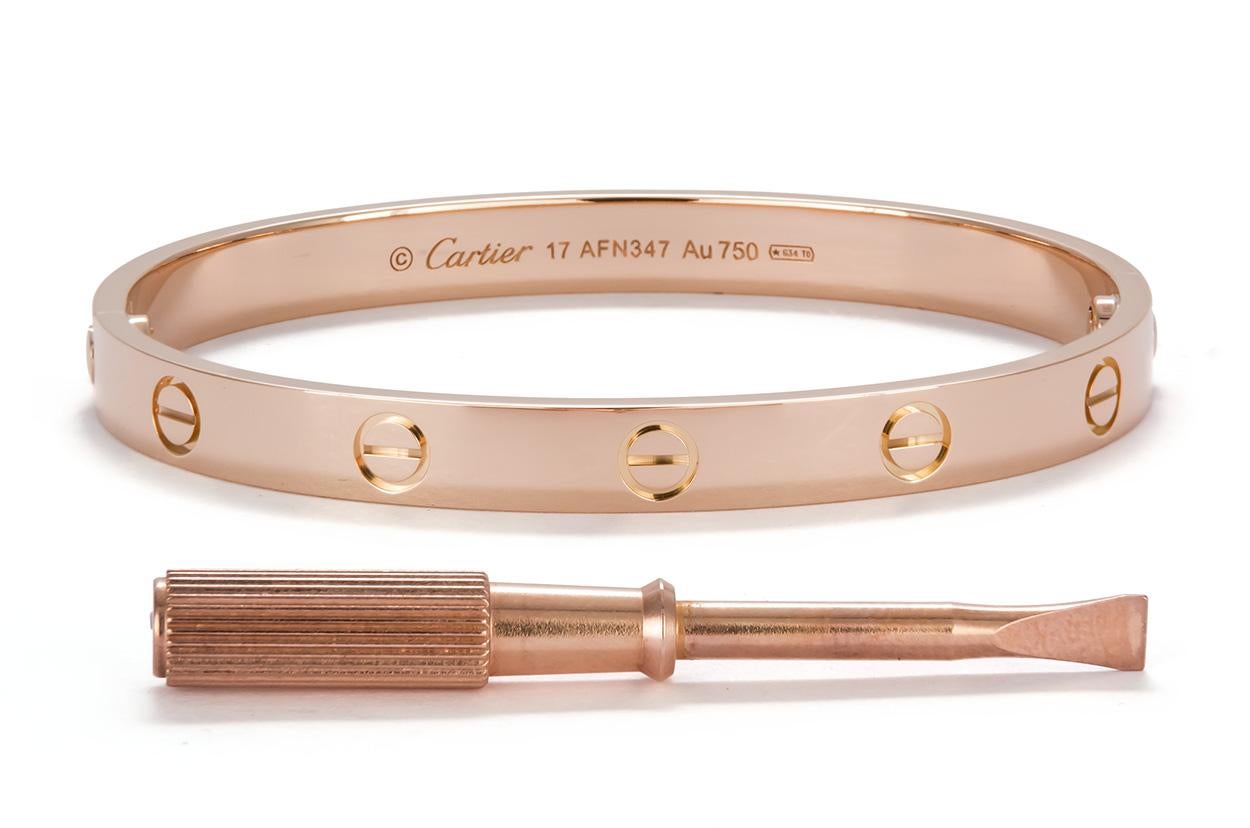 We are pleased to offer this Authentic Cartier 18K Rose Gold Love Bangle Size-17. This bracelet was just sent to Cartier New York for a polish, it looks good as new. It features the new style screw system and comes complete with the original factory