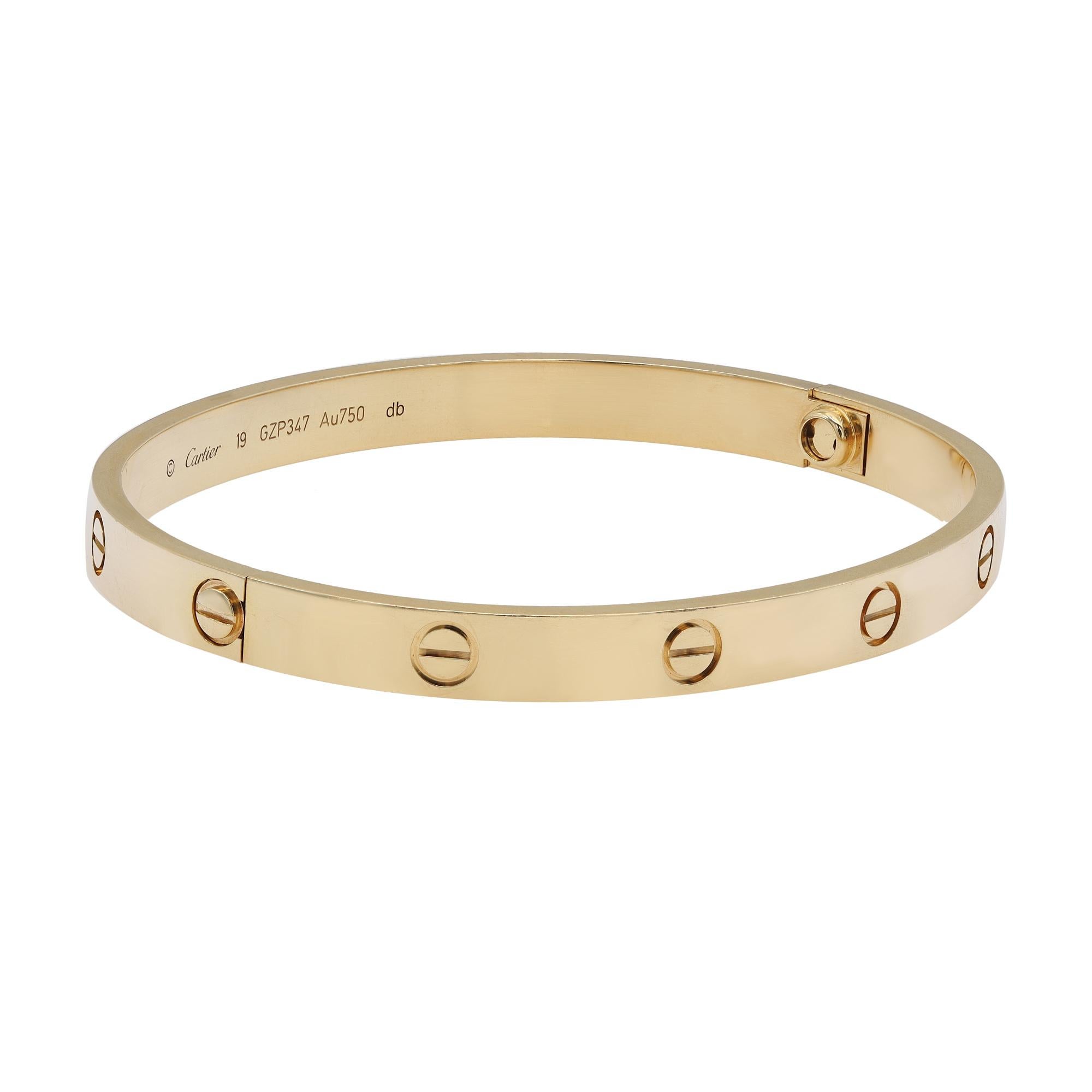 Cartier Love bracelet crafted in 18K yellow gold. New style screw system. Width: 6.1mm. Size 19. Great pre-owned condition. The bracelet is marked 