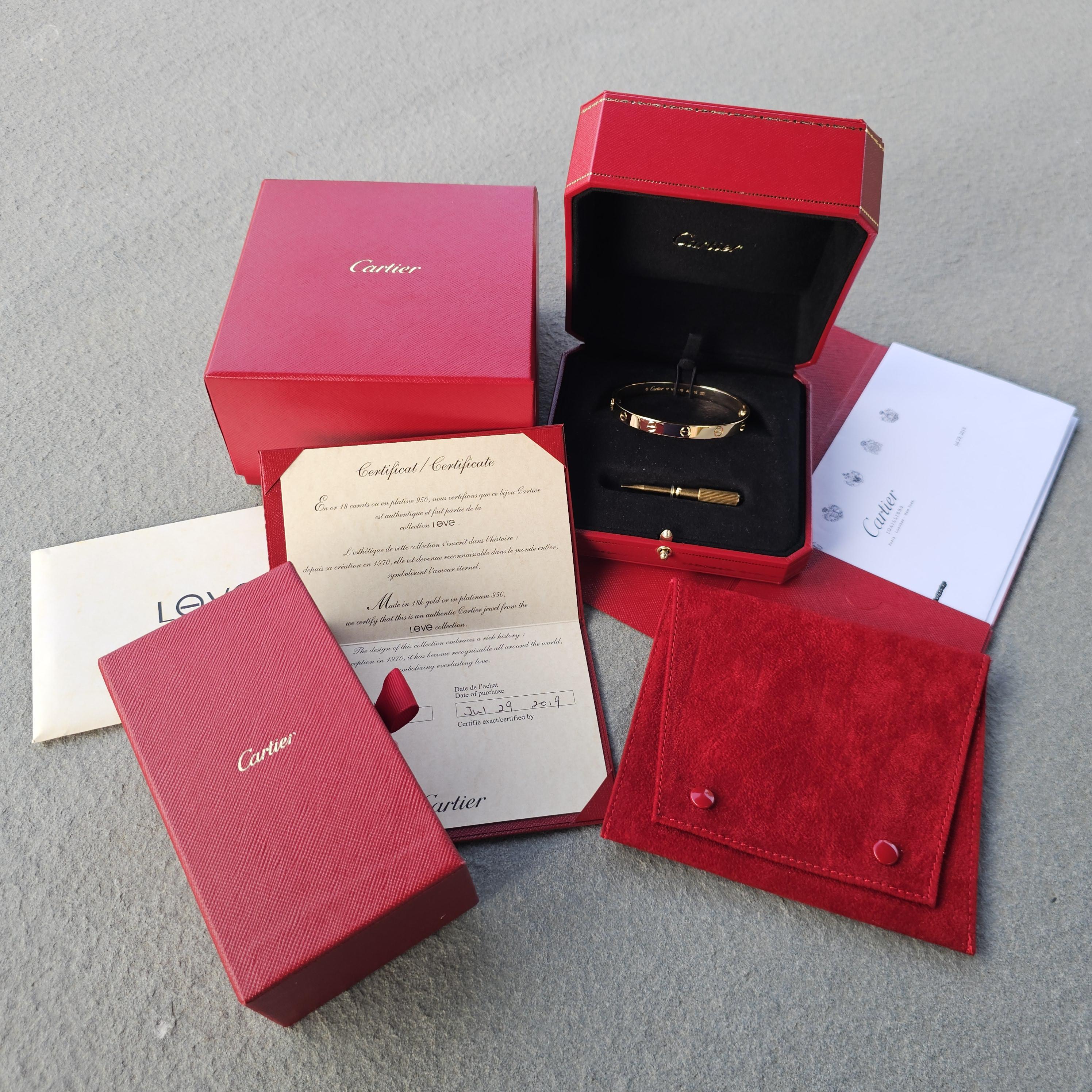 Elevate your jewelry collection with this exquisite Cartier Love Bangle Bracelet. Crafted from 18k yellow gold, its sleek design features iconic screw motifs that symbolize enduring love. This piece is perfect for those who appreciate timeless