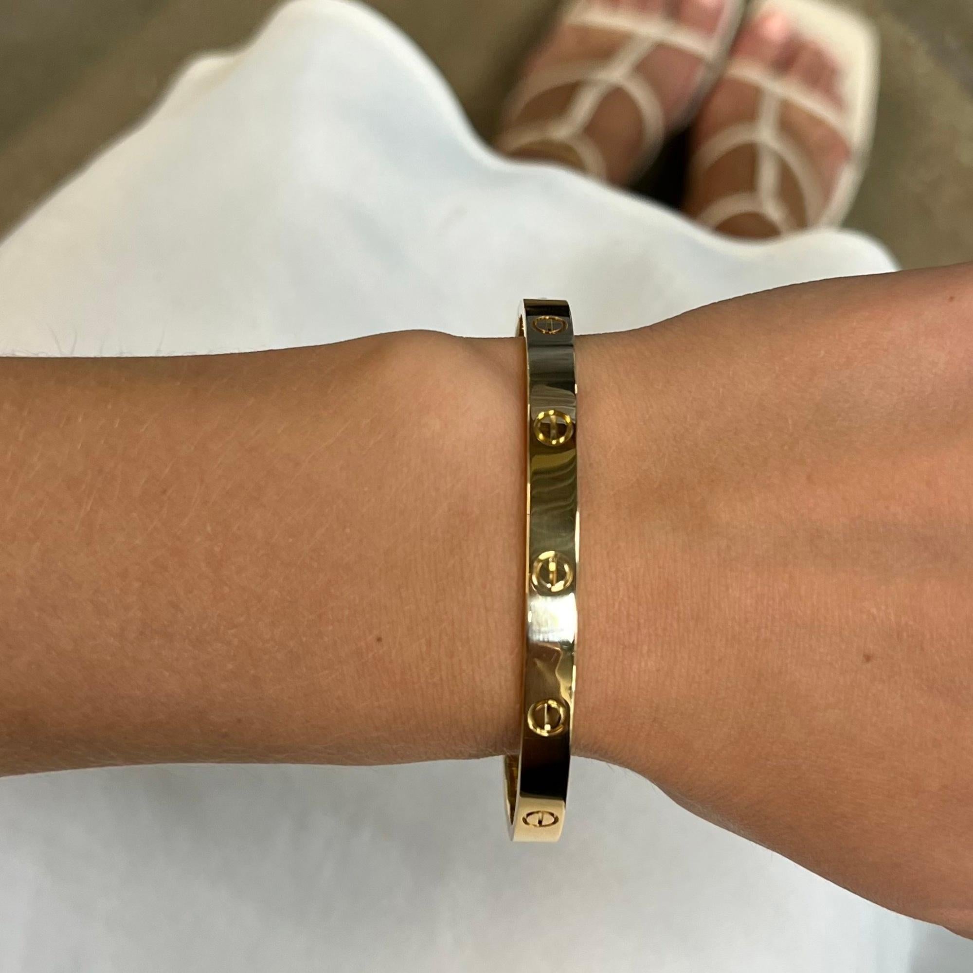 Cartier classic 18K yellow gold Love bangle bracelet size 20. Width: 6.1mm. New style screw system. Excellent pre owned condition. Looks unworn. Come with a screwdriver. No original box included. Comes with a presentable gift box. 