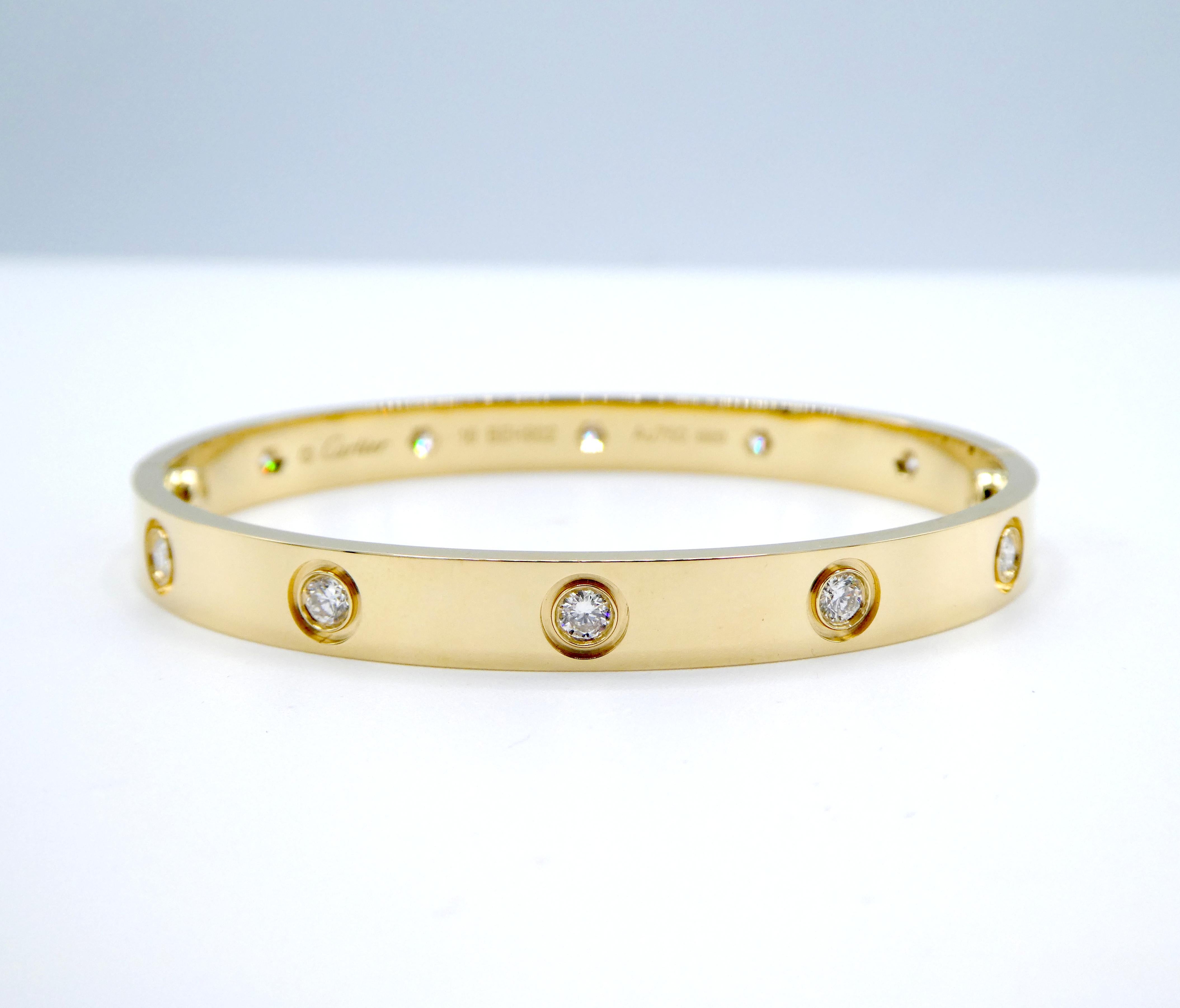 Cartier Love Bracelet 10 Diamonds 18 Karat Yellow Gold Bangle Size 16 Estate

Designer: Cartier
Metal: 18k yellow gold
Weight: 30.17 grams
Size 16
Width: 6.1mm
Diamonds: 10 round brilliant cut diamonds 0.96ctw F-G VS
Signed 
