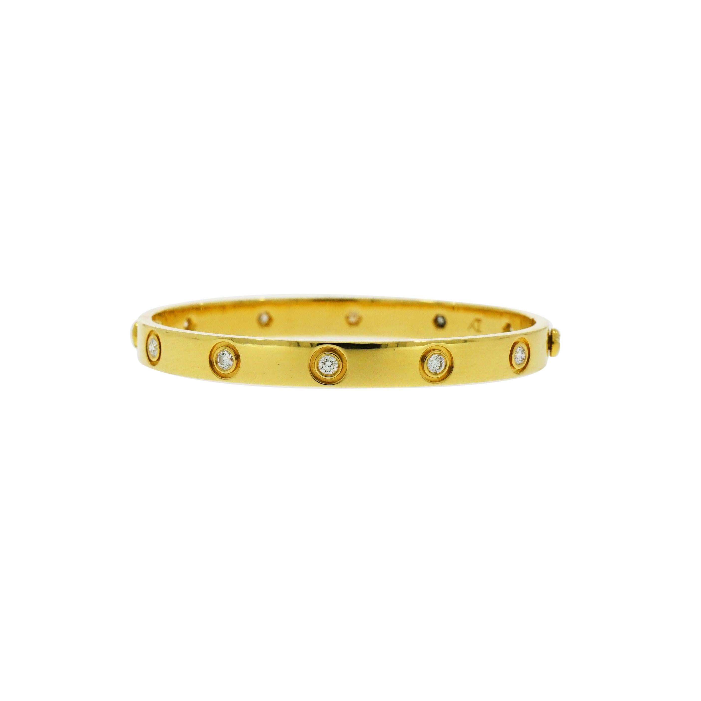 Iconic and Timeless, this Genuine Cartier Love bracelet crafted in 18k yellow gold and embedded with 10 diamonds around it. 
The look is to be stacked with similar style bangles or worn as a stand-alone piece. 
Completed with the original Cartier