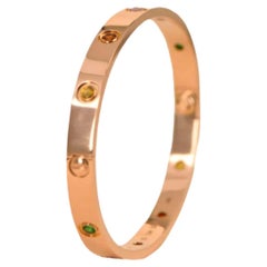Cartier Bracelet Love 10 en or rose avec plusieurs pierres précieuses taille 17