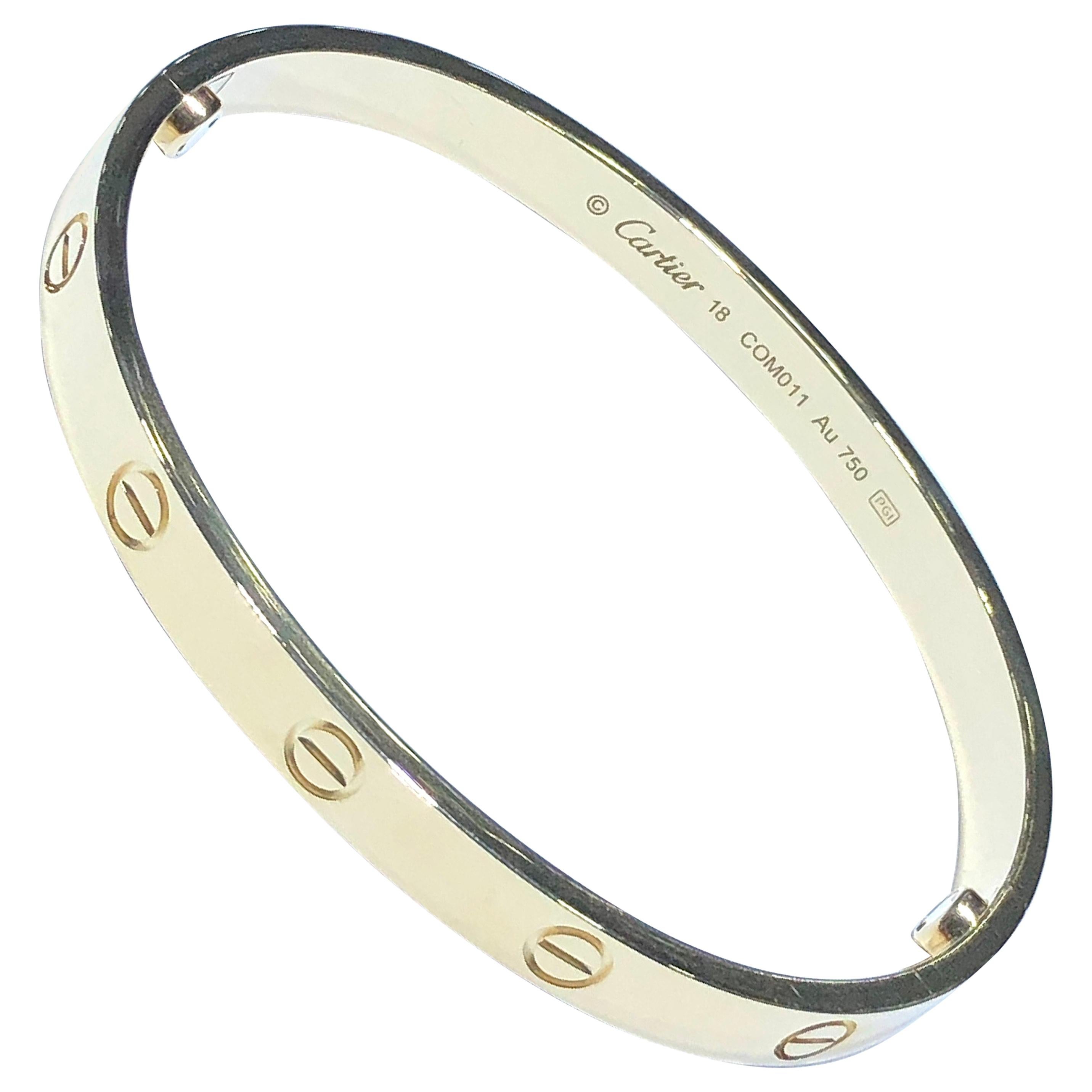 A signature 18k yellow gold Cartier bracelet from the Love collection. The bracelet is a size 18 and has a gross weight of 32.50 grams. Original box and key included. Pristine condition, shows no scratches or wear. Bracelet is hallmarked Serial #