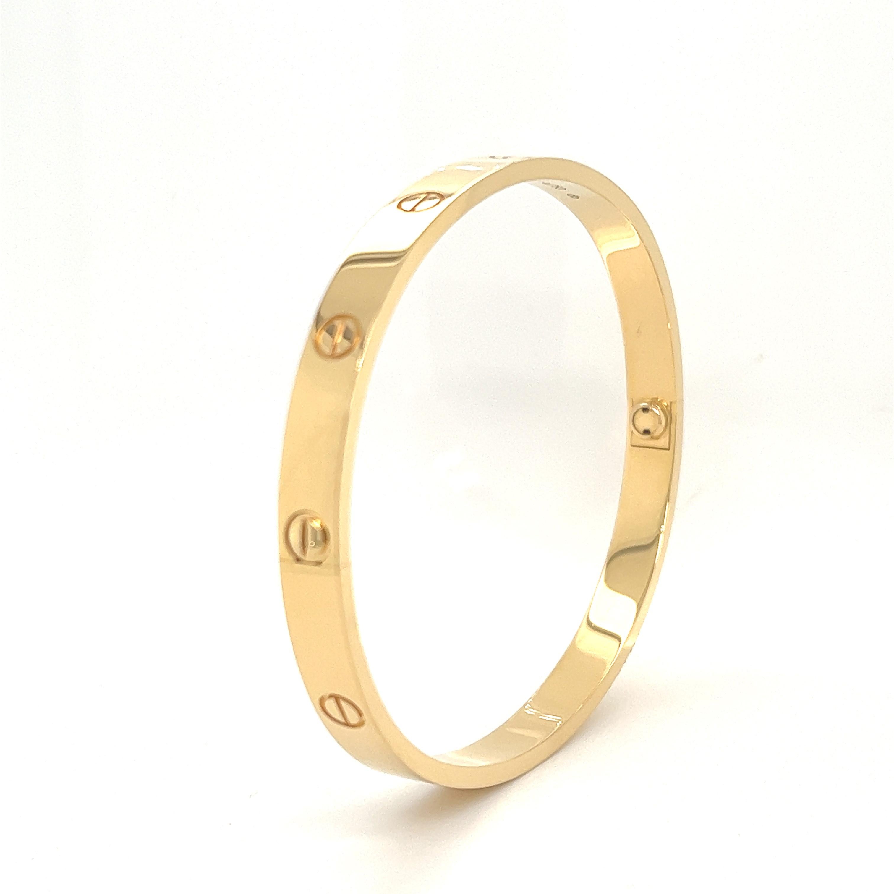 A signature 18k yellow gold Cartier bracelet from the Love collection. The bracelet is a size 20 and has a gross weight of 39.6 grams. Original Cartier box, key and paperwork all included in purchase. This bracelet is in pristine condition as paper