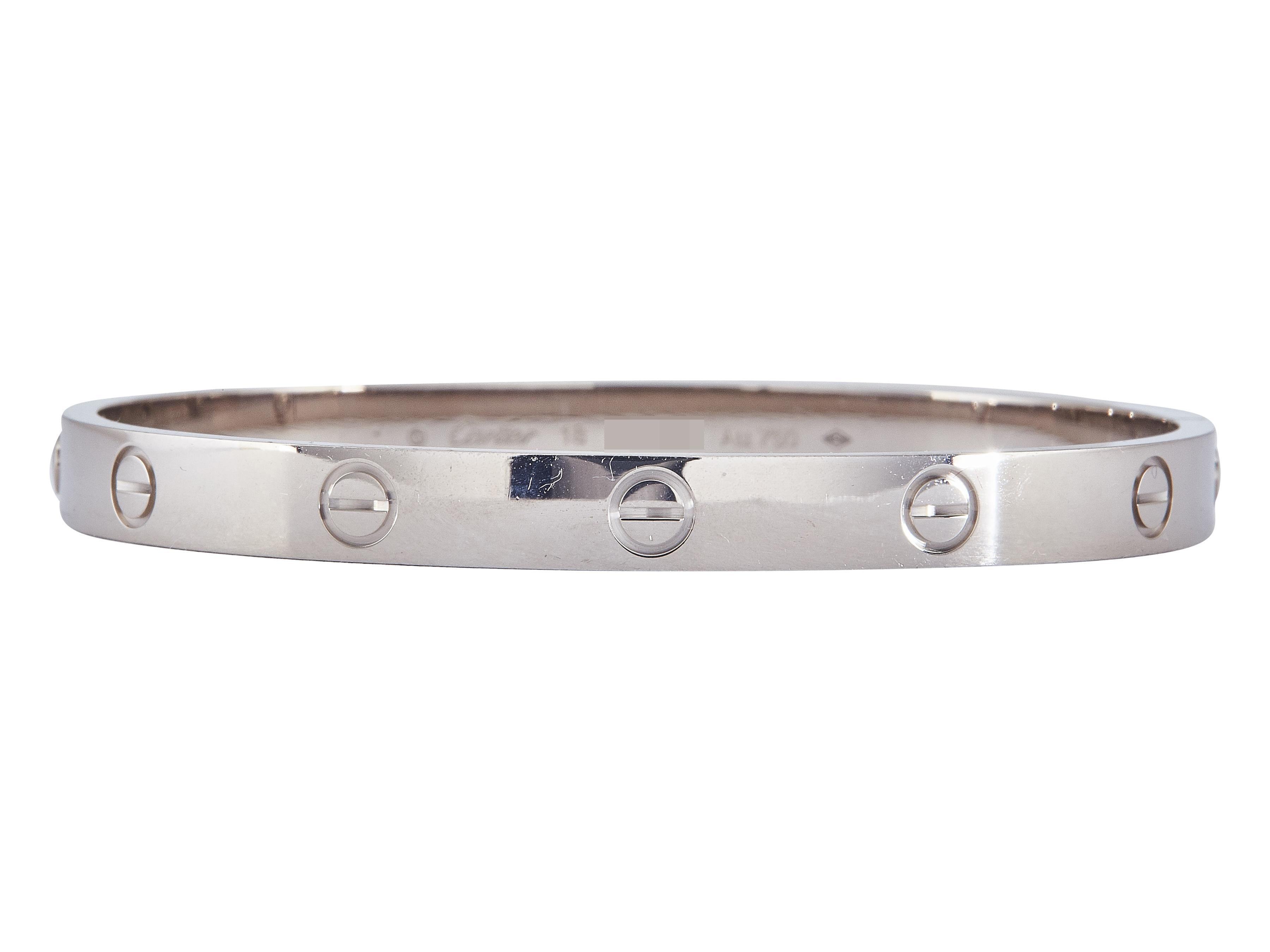 The bracelet: A Cartier LOVE bangle bracelet designed in eighteen karat white gold. This Classic model is a size 18. 

The bracelet is in excellent condition, with only a few minor scratches that are expected with normal wear. The brand has