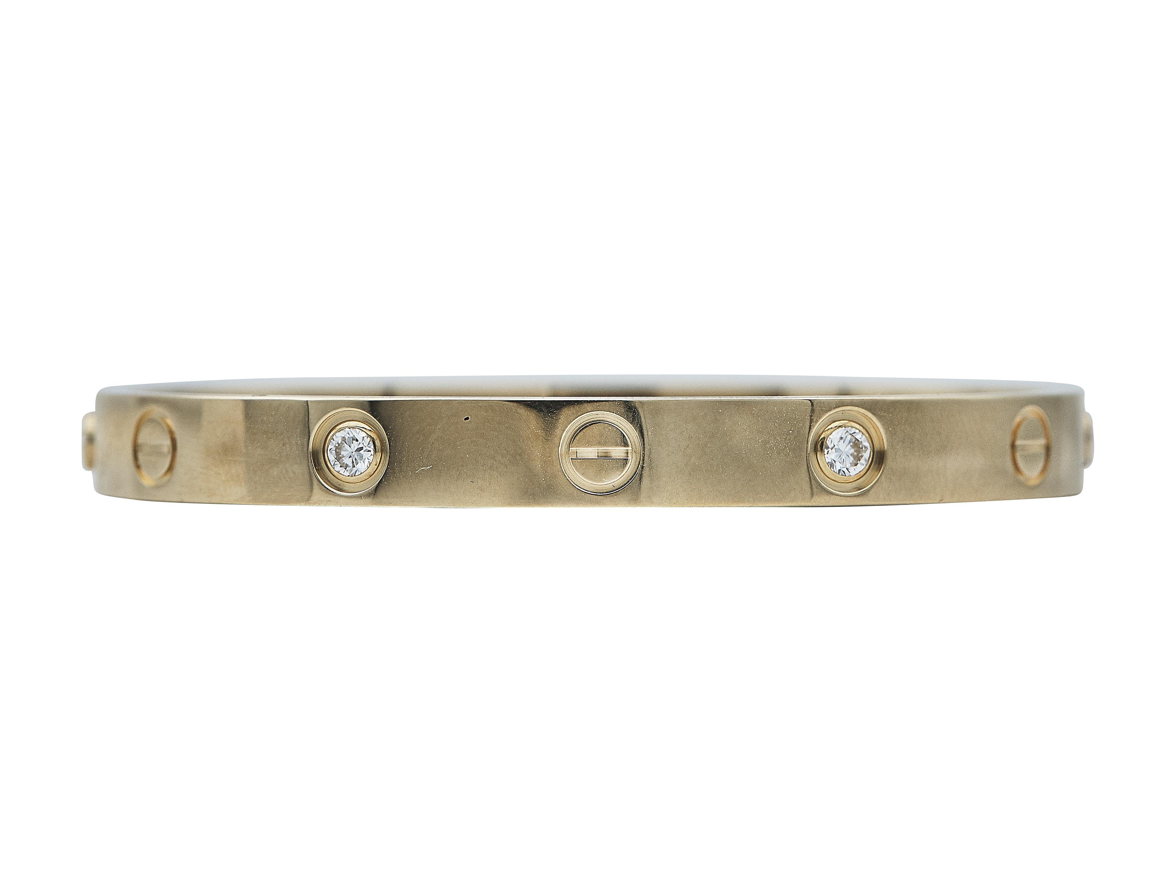 The bracelet: A Cartier Love bangle bracelet. This Classic Model is designed in eighteen karat yellow gold and set with four round brilliant-cut diamonds. It is a wrist size 16.

The bracelet is in excellent condition, with only a few minor