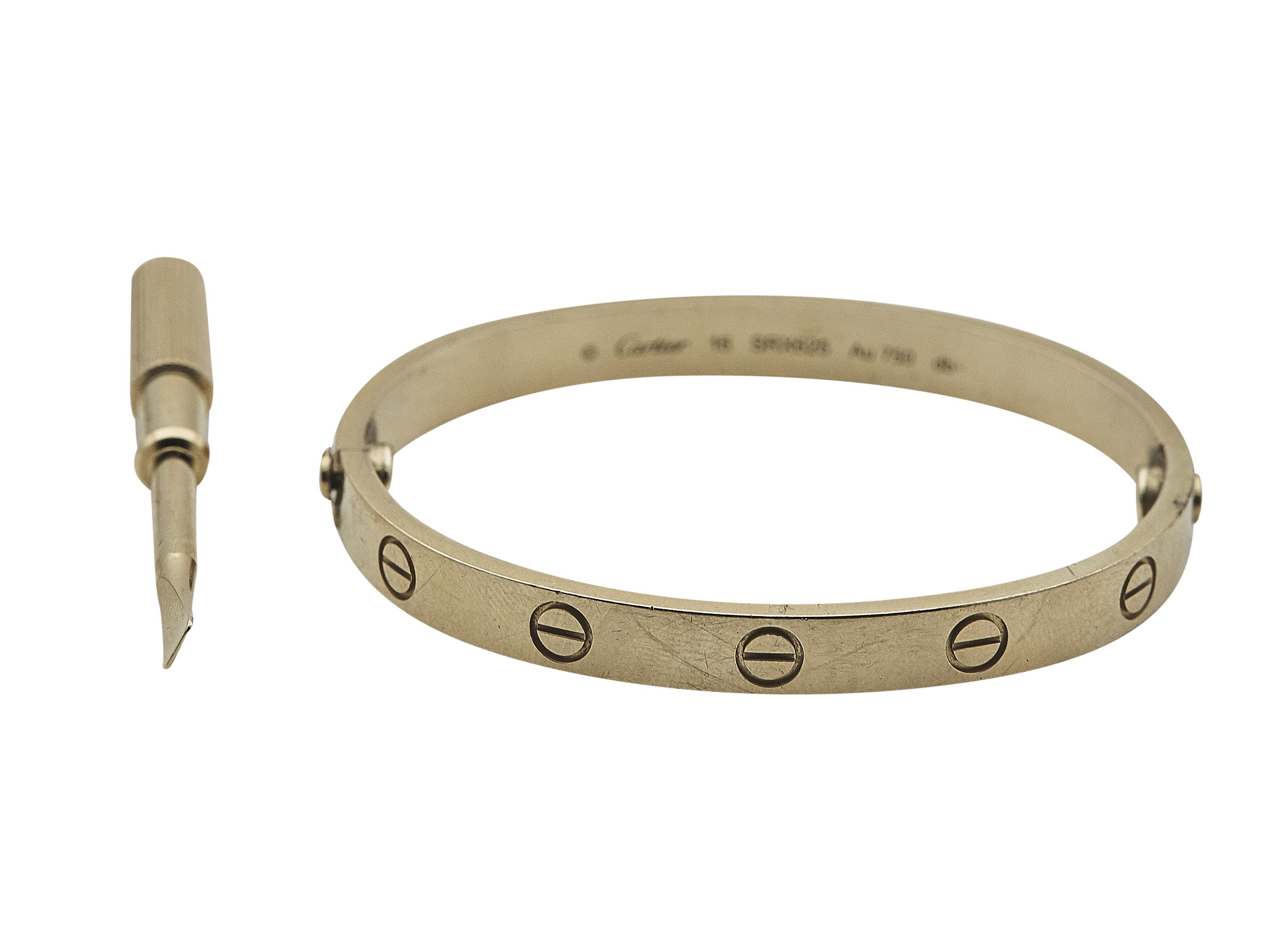 The bracelet: A Cartier Love bangle bracelet. This Classic model is designed in eighteen karat yellow gold. It is a size 16.

The bracelet is in good condition with moderate surface wear and minor scratching. Closing mechanism works well. In round