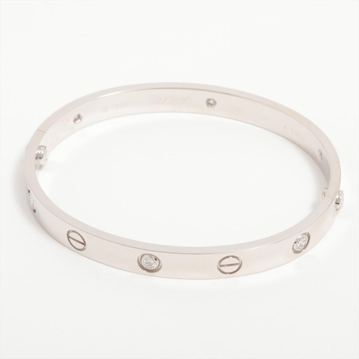 Brand : Cartier
Description: Love Half Diamond Bracelet 
Metal Type: 750 (WG) / White Gold
Total Weight: 33.2g
Size: 17
Diamonds: Four
Diamonds Weight: 0.42ct
Width: 6.1 mm
Opening/Closing System: Old
Condition: Preowned; small signs of