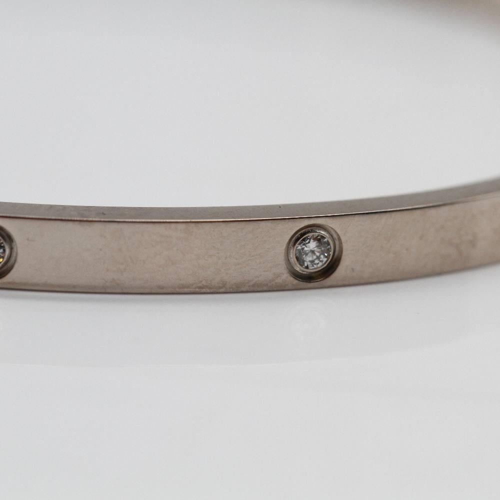 CARTIER LOVE gold bracelet for women : 10 diamonds 18 kt. white gold : 21 grams : 17.5 cm long : 17.5 cm long : Screw clasp (steel screwdriver included). Measurements: 3.7 mm wide and 2.1 mm thick. This bracelet is in excellent condition, with no