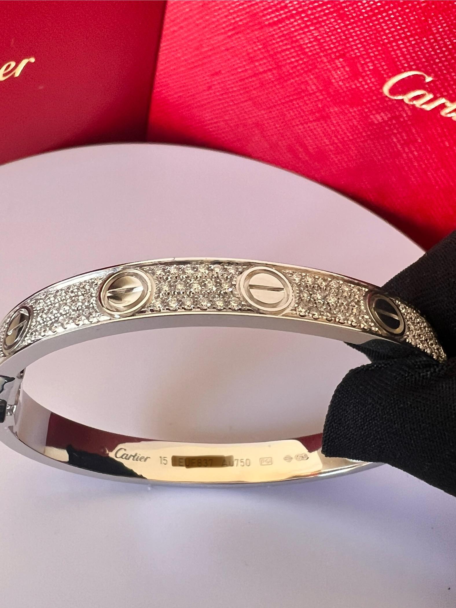 CARTIER LOVE BRACELET
Cartier 'Love' bangle bracelet crafted in 18 karat white gold with diamond screw tops and pave set round brilliant cut diamonds (D-F in color, VVS clarity)
Signed Cartier, 750, with serial number and hallmarks 
The bracelet is