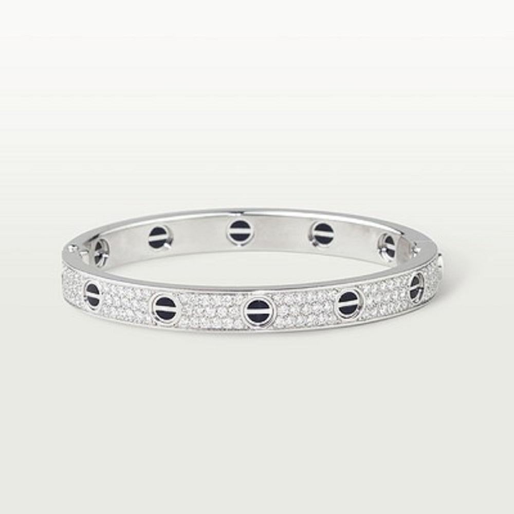 CARTIER LOVE BRACELET size 18
Cartier 'Love' bangle bracelet crafted in 18 karat white gold with diamond screw tops and pave set round brilliant cut diamonds (D-F in color, VVS clarity), ceramique noir
Signed Cartier 750, with serial number and