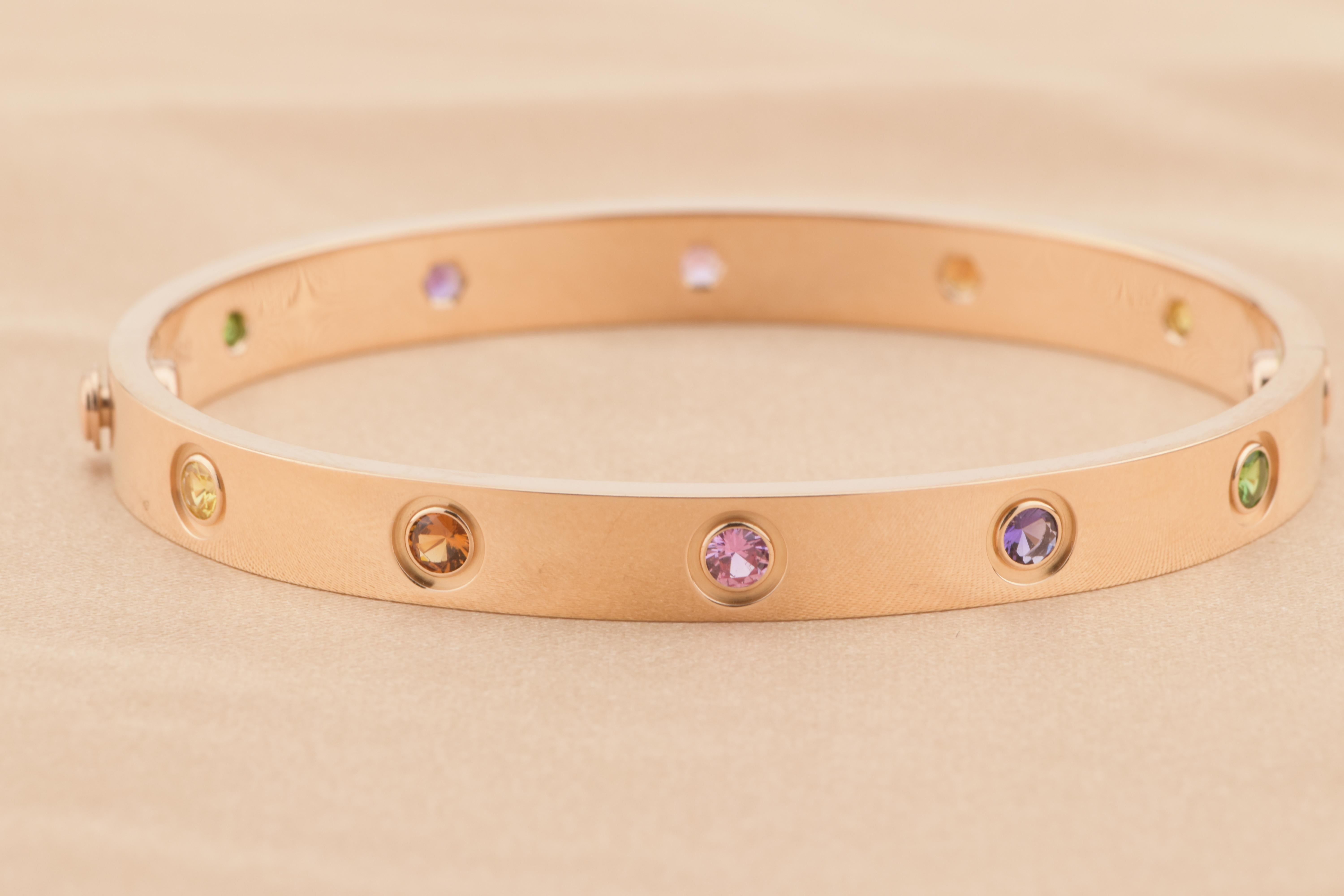 LOVE bracelet, 18K rose gold, set with 2 pink sapphires, 2 yellow sapphires, 2 green garnets, 2 orange garnets, and 2 amethysts. 
Comes with Cartier Box / Dandelion Antiques Guarantee Card. Size 16
__________________________________

Dandelion