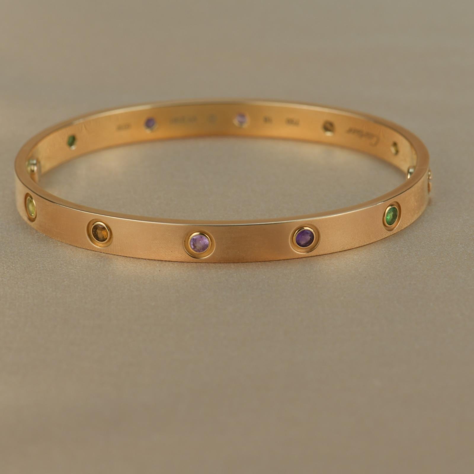 LOVE bracelet, 18K rose gold, set with 2 pink sapphires, 2 yellow sapphires, 2 green garnets, 2 orange garnets, and 2 amethysts. 
Comes with Cartier Box / Authentic card.  Size 18
__________________________________

Dandelion Antiques Code