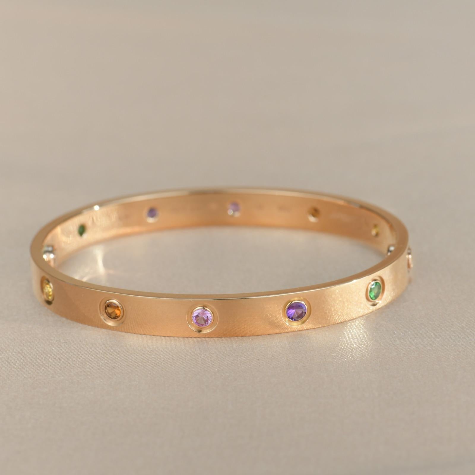 LOVE bracelet, 18K rose gold, set with 2 pink sapphires, 2 yellow sapphires, 2 green garnets, 2 orange garnets, and 2 amethysts. 
Comes with Cartier Box / Authentic card. Size 16
__________________________________

Dandelion Antiques Code
