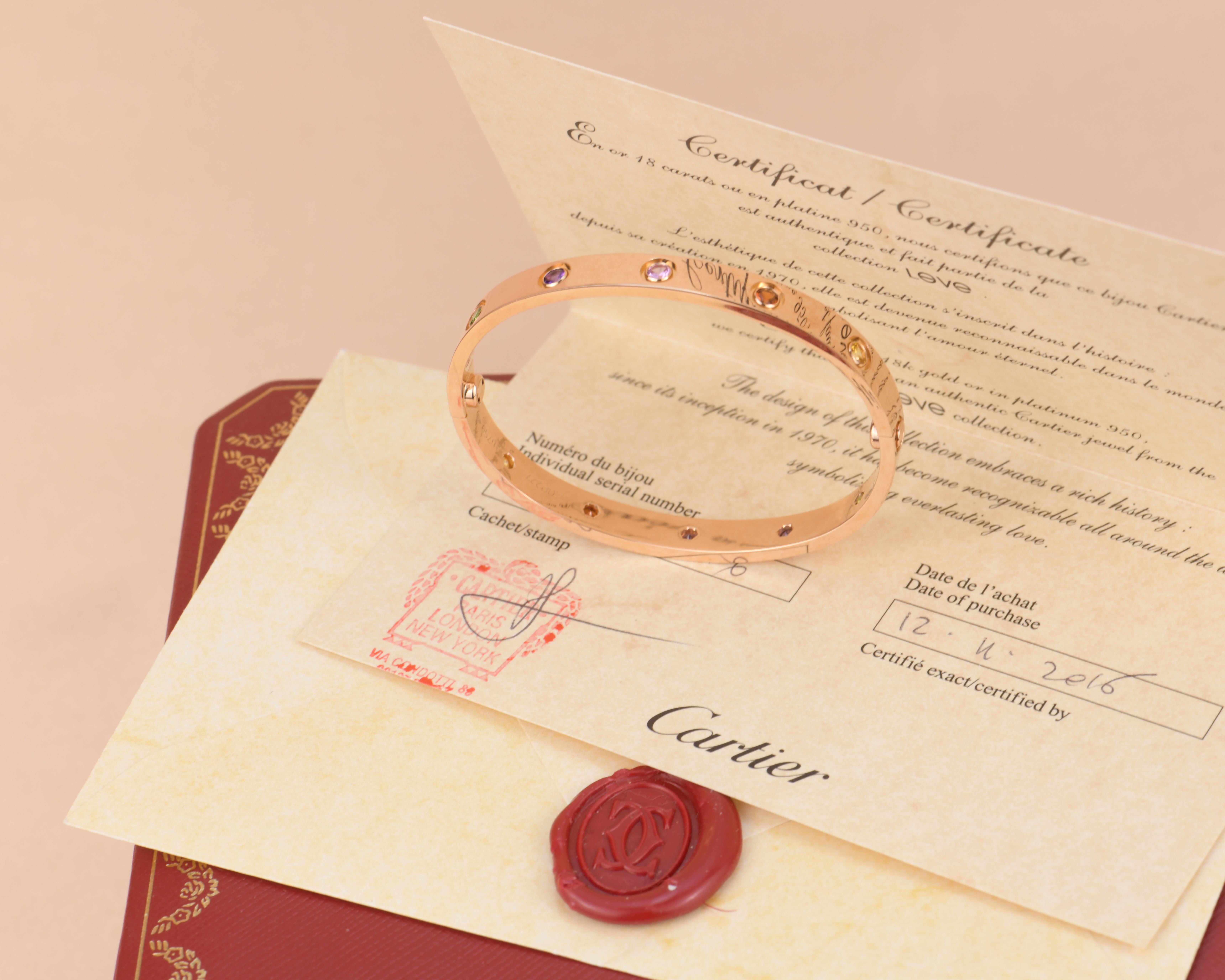 LOVE bracelet, 18K rose gold, set with 2 pink sapphires, 2 yellow sapphires, 2 green garnets, 2 orange garnets, and 2 amethysts. 
_____________________________________________________________
Dandelion Antiques Code AT-1378
Brand Cartier
Model