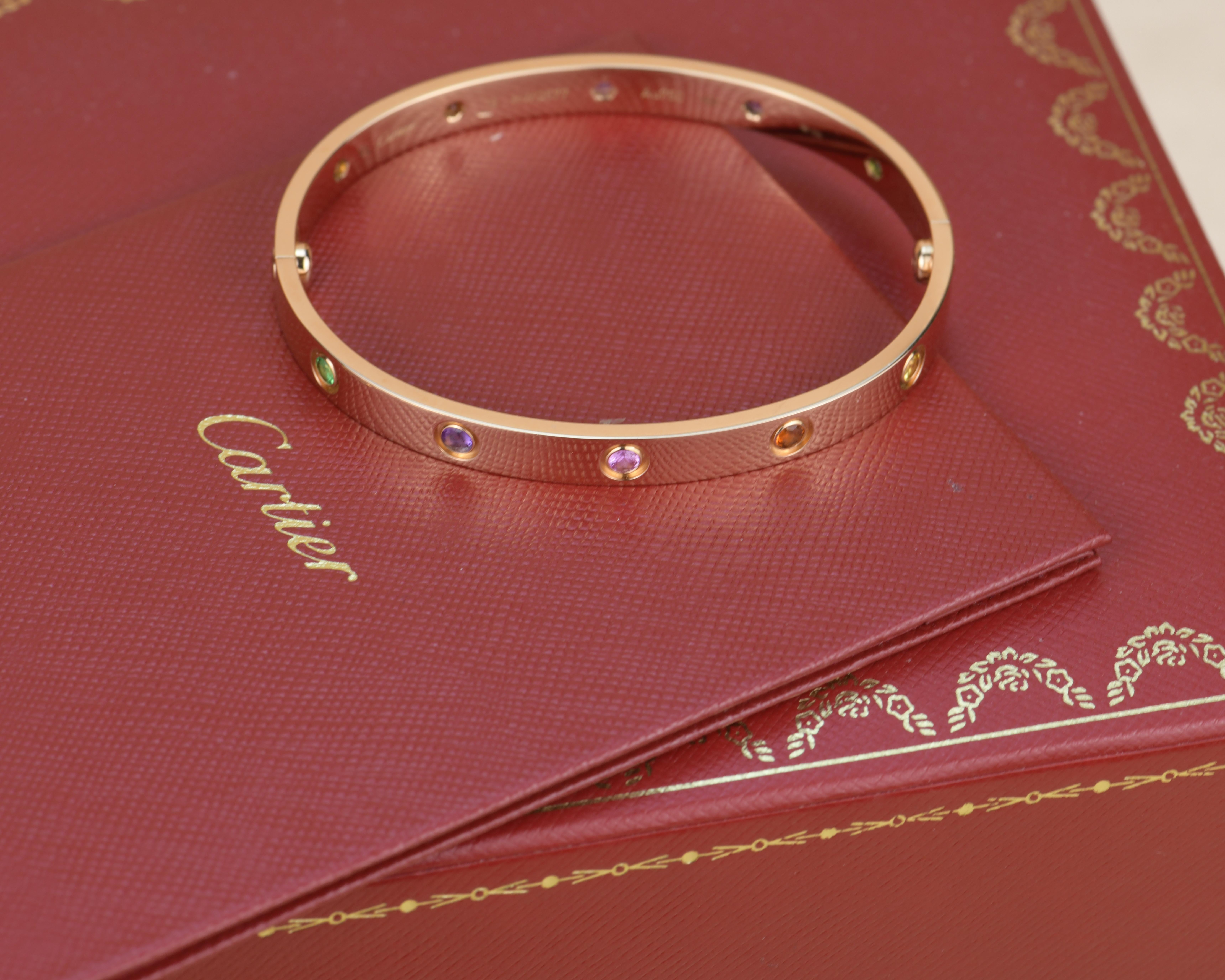 LOVE bracelet, 18K rose gold, set with 2 pink sapphires, 2 yellow sapphires, 2 green garnets, 2 orange garnets, and 2 amethysts. 
_____________________________________________________________
Dandelion Antiques Code AT-1406
Brand Cartier
Model