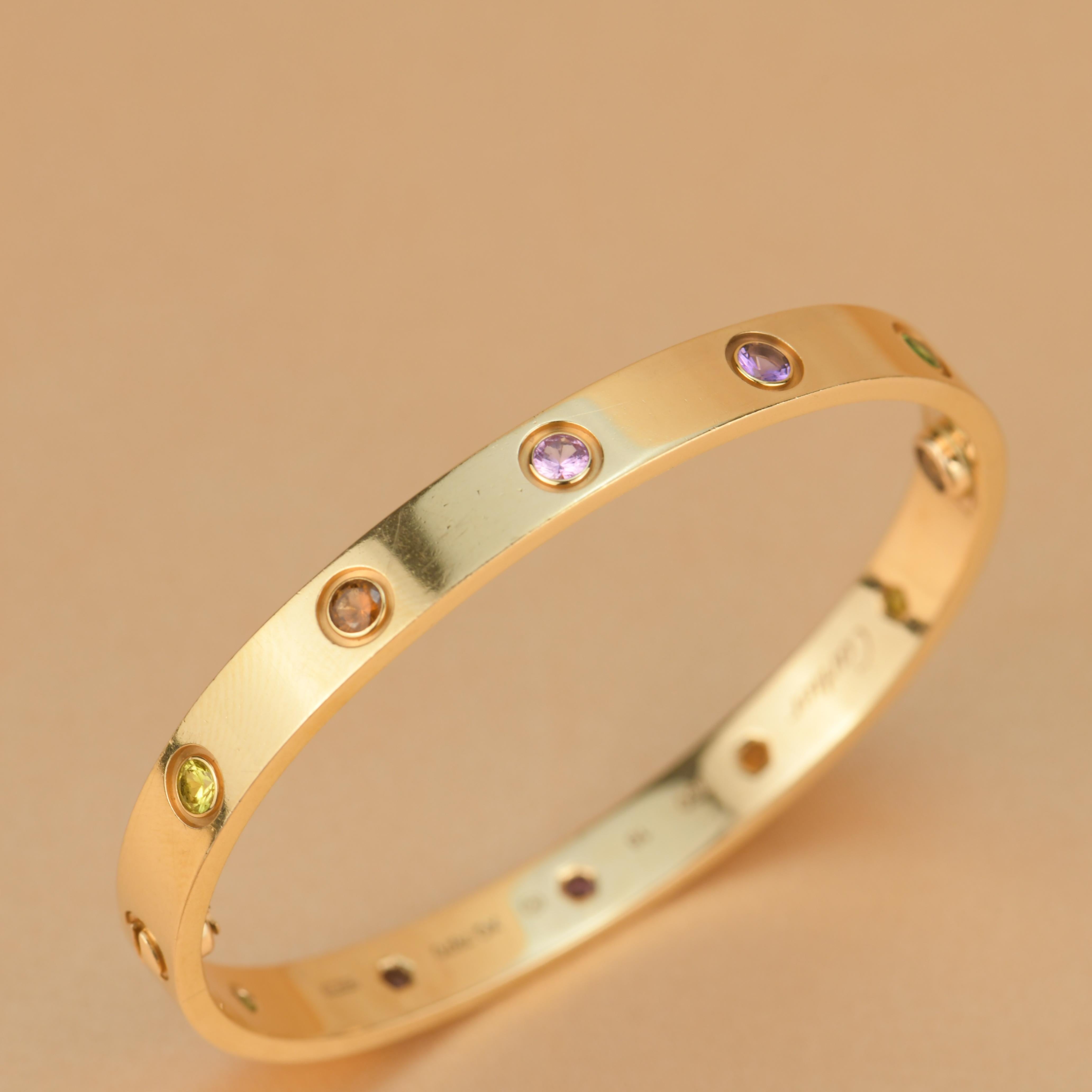 LOVE bracelet, 18K rose gold, set with 2 pink sapphires, 2 yellow sapphires, 2 green garnets, 2 orange garnets, and 2 amethysts. 
Comes with Cartier Box / Authentic card. Size 16
__________________________________

Dandelion Antiques Code