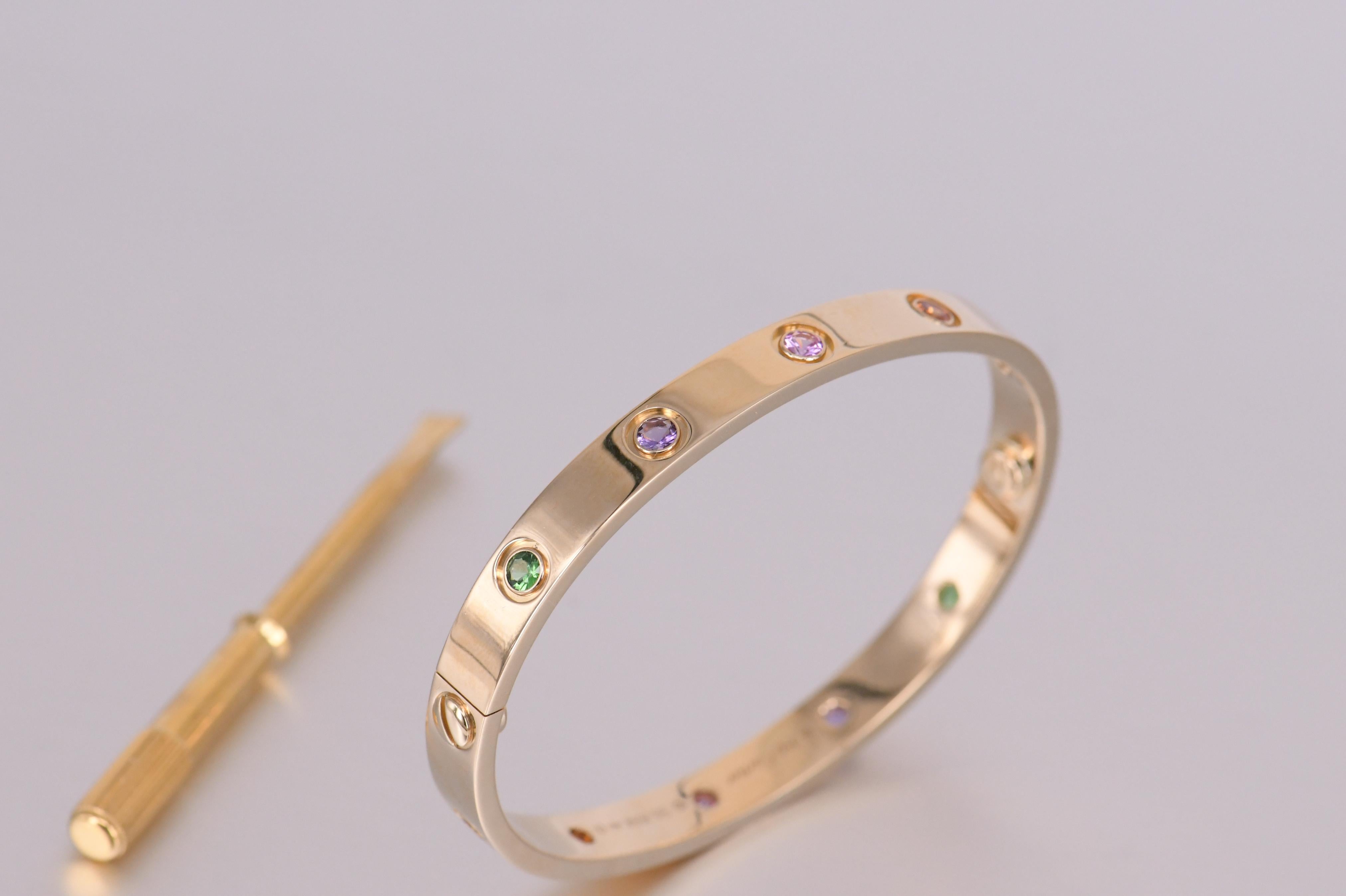LOVE bracelet, 18K yellow gold, set with 2 pink sapphires, 2 yellow sapphires, 2 green garnets, 2 orange garnets, and 2 amethysts. Comes with a screwdriver and Dandelion Antiques presentation box    

__________________________________

Dandelion