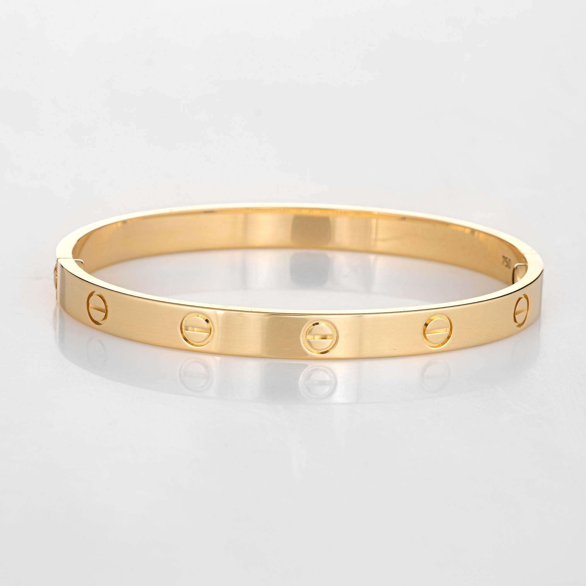 Pre owned Cartier love bracelet crafted in 18 karat yellow gold.  

The bracelet is a size 18 and features the new screw system (easier to screw on and off compared to older model Cartier love bracelets).

The bracelet is in excellent condition and