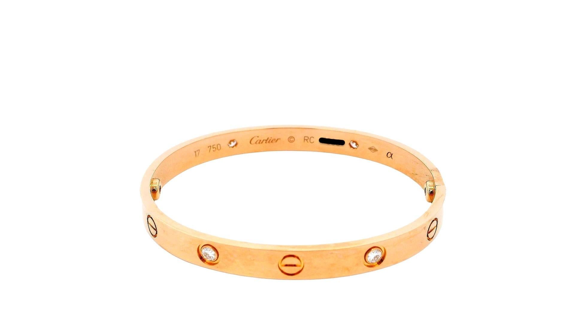 This is a Cartier Love bracelet in size 17, crafted from 18K rose gold. It features a sleek, minimalist design adorned with four brilliant-cut diamonds and the iconic screw motifs, symbolizing love and commitment. The bracelet comes with its