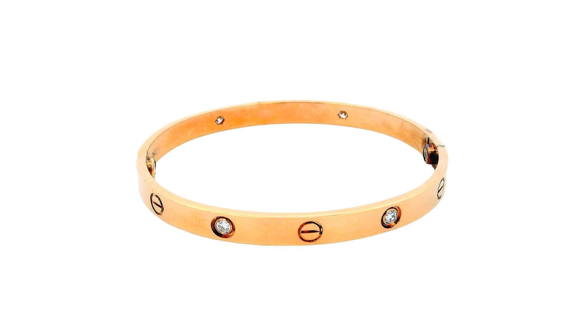This is a Cartier Love bracelet in size 18, crafted from 18K rose gold. It features a sleek, minimalist design adorned with four brilliant-cut diamonds and the iconic screw motifs, symbolizing love and commitment. The bracelet comes with its
