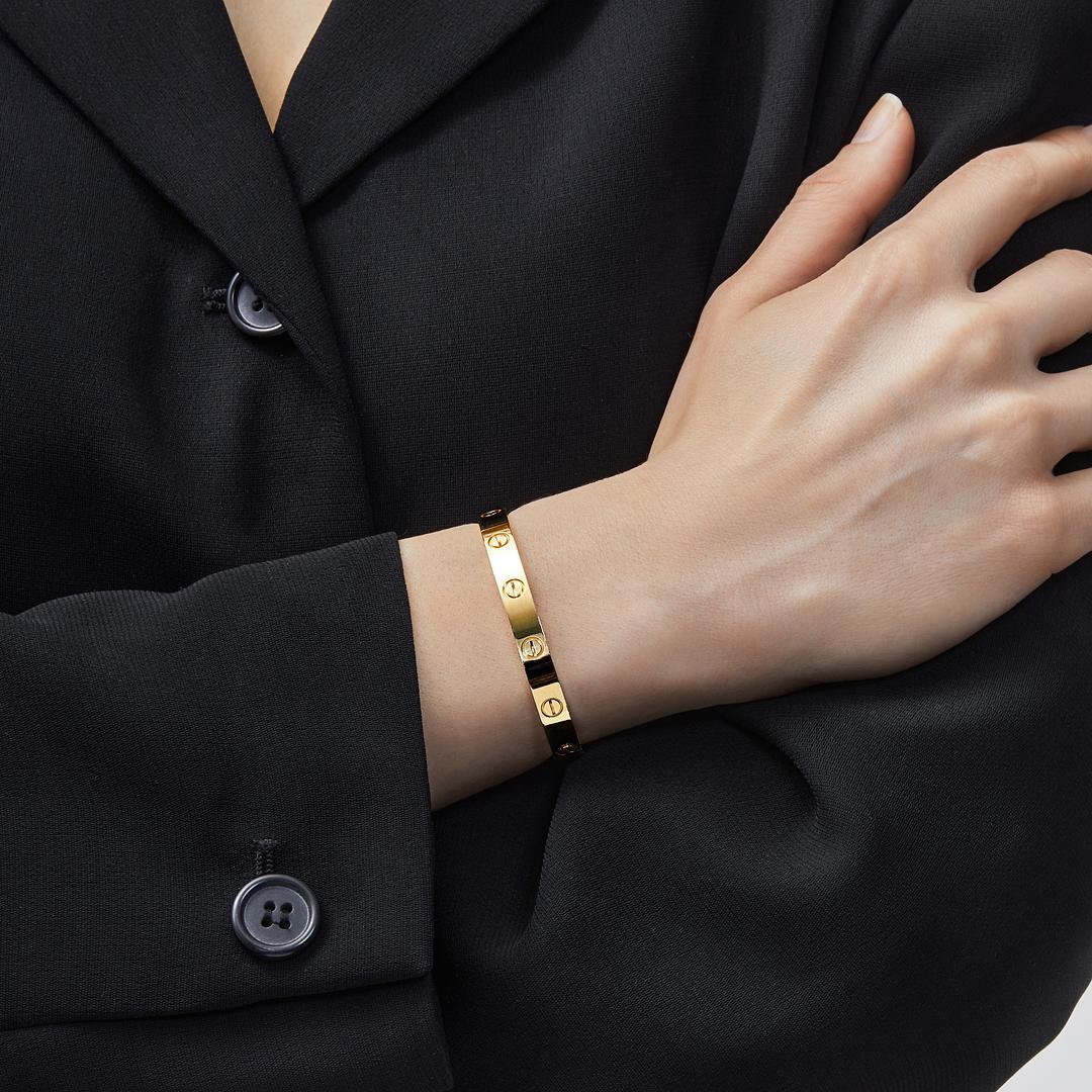 Le bracelet d'amour de Cartier, l'un des modèles les plus connus de la mode, est une pièce emblématique de la joaillerie moderne. Mariant fonction et esthétique, le bracelet en or jaune massif 18 carats s'ouvre et se ferme à l'aide du tournevis de