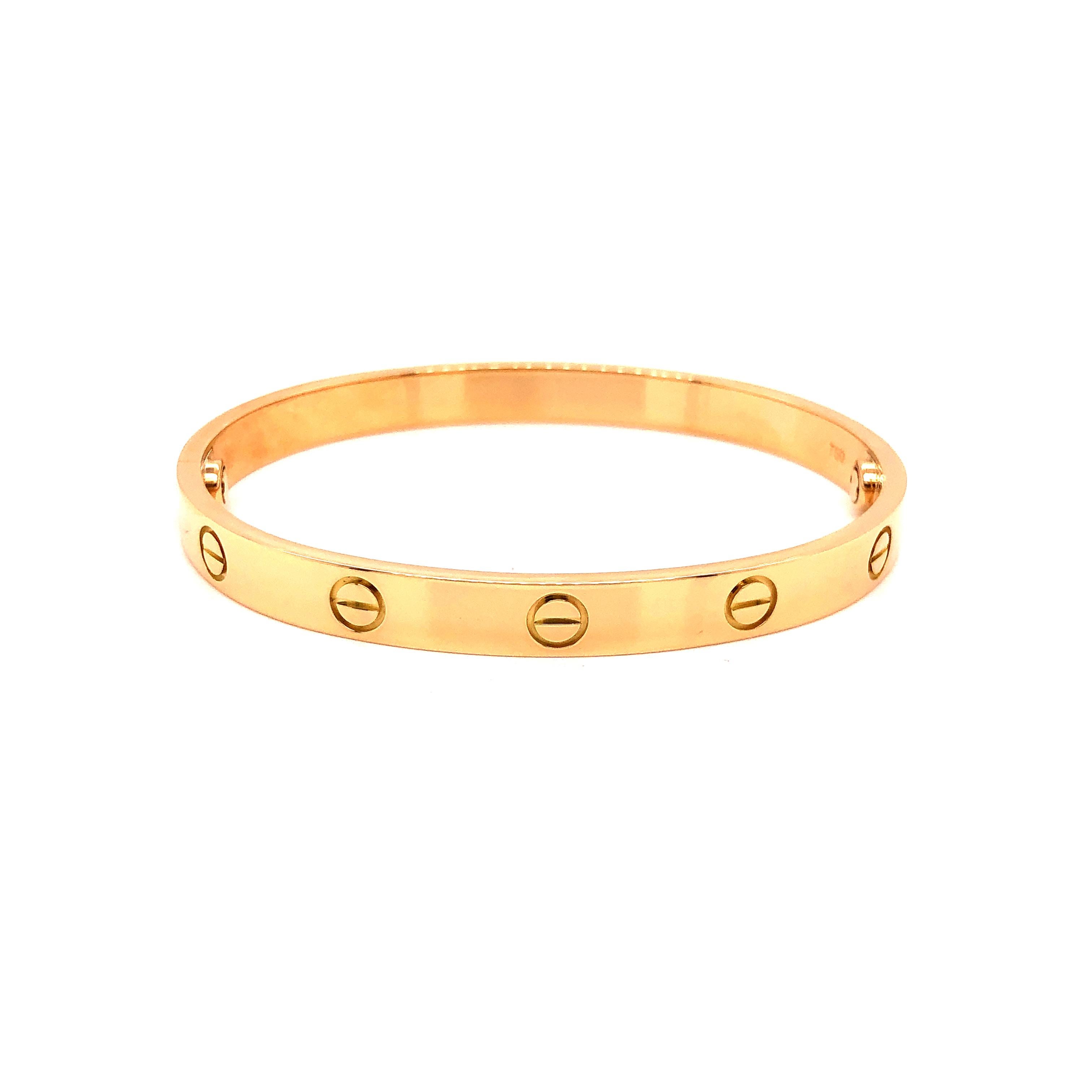 A signature 18k Yellow Gold Cartier bracelet from the Love collection. The bracelet is a size 17. Original box and key included as well as Cartier paperwork. Pristine condition, shows no scratches or wear. . New screw system. All Photos taken under