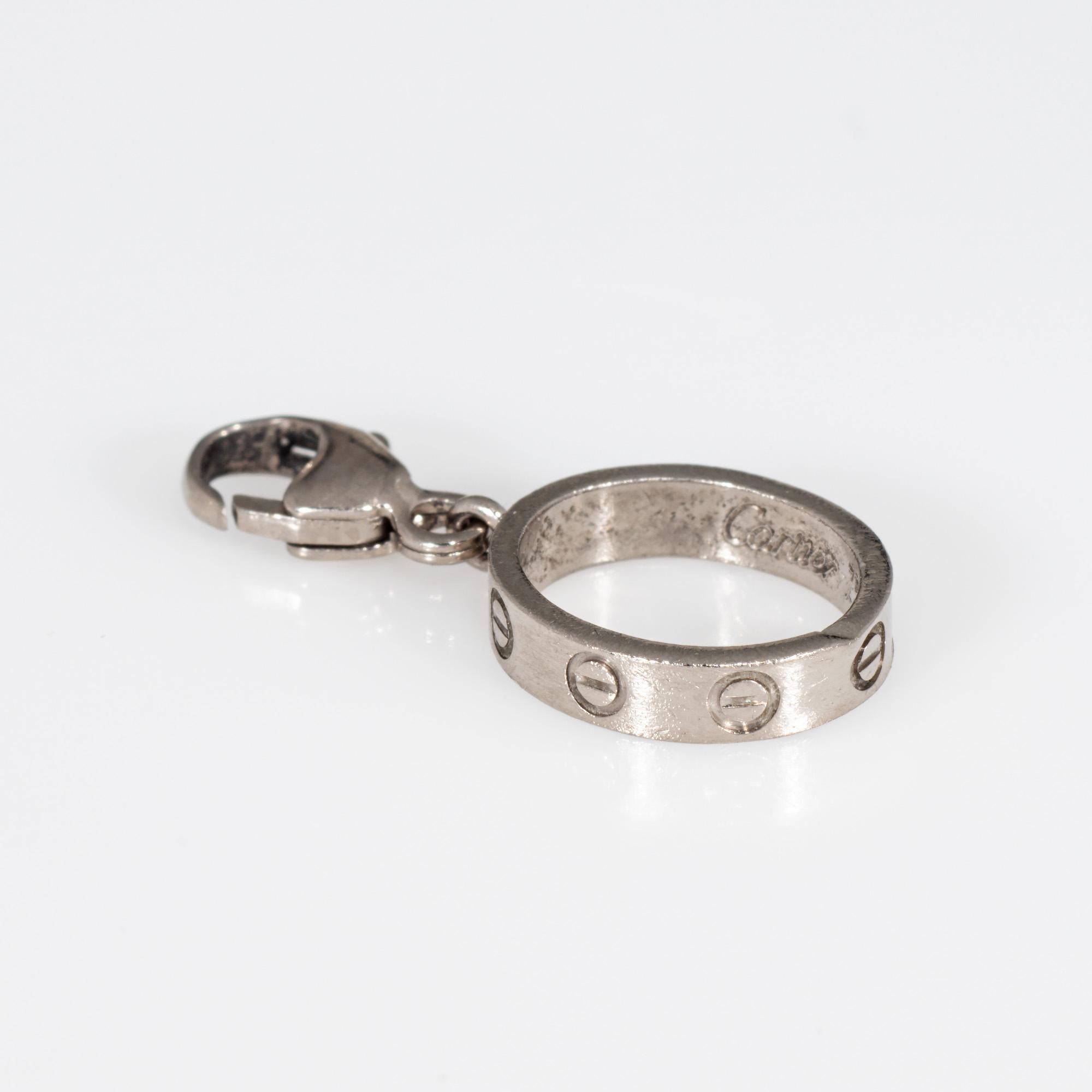 Cartier love charm (or pendant), crafted in 18 karat white gold.  

The petite love charm is great for wear on a charm bracelet or worn as a pendant on a chain. 

The charm is in very good condition and was lightly cleaned and