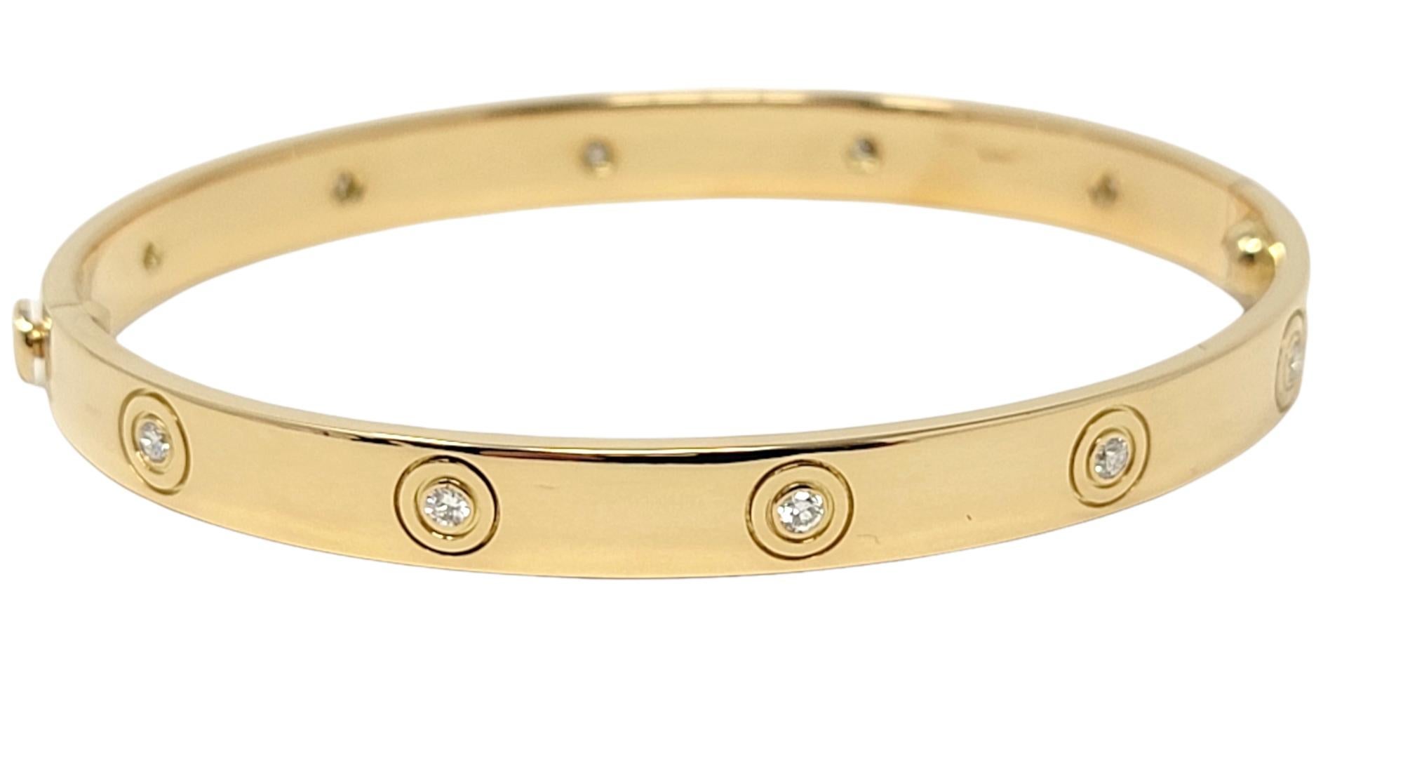 Vintage Iconic Love Collection bangle bracelet with diamonds from luxury jeweler, Cartier. This simple, yet effortlessly timeless piece makes a chic statement on the wrist. Made of beautifully polished 18 karat yellow gold, the thin designer bangle