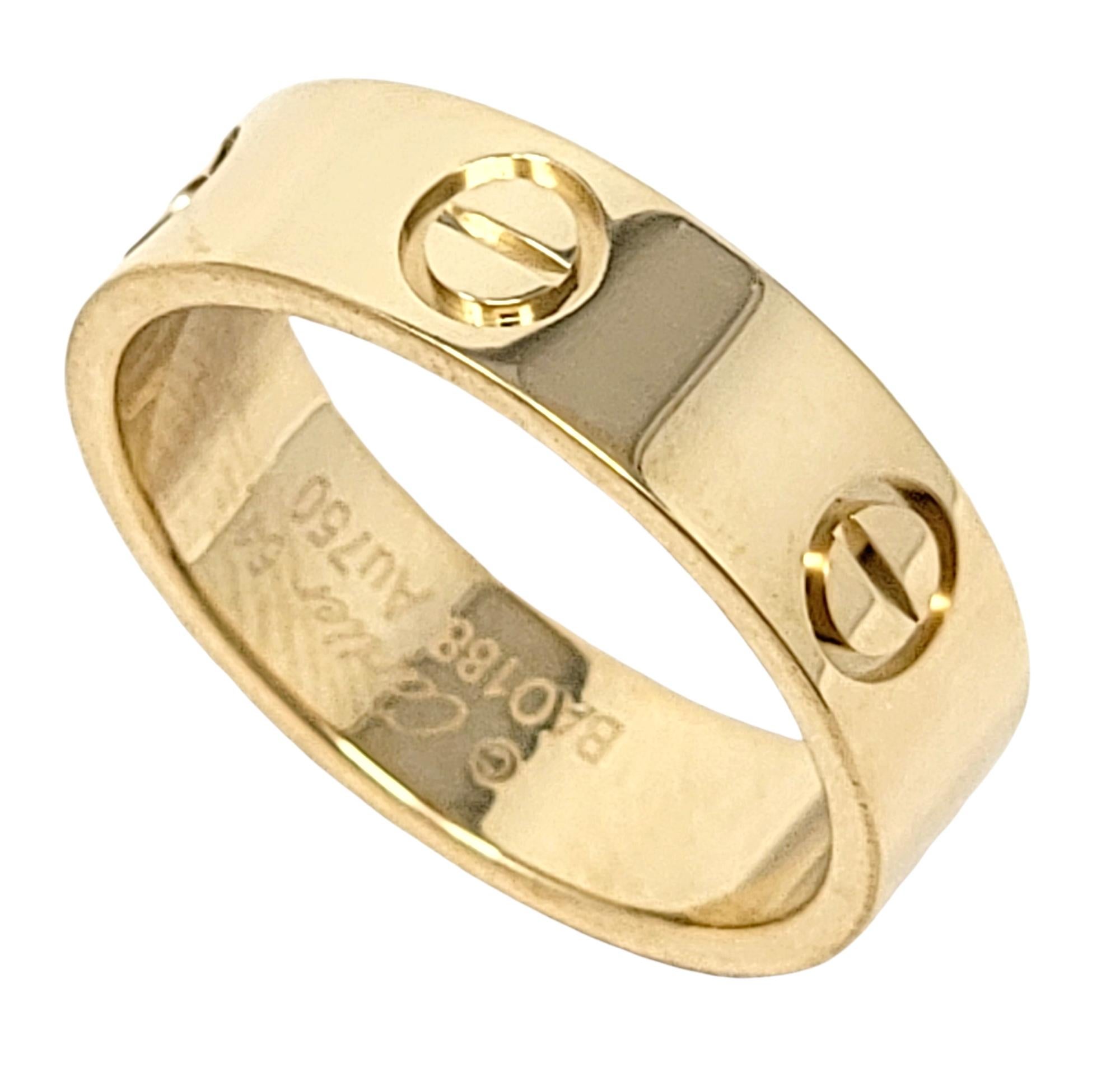 Iconic Love Collection 18 karat polished gold band ring from luxury jeweler, Cartier. This simple, yet timeless piece makes a chic statement on the finger with its clean lines, perfect symmetry, and flawless elegance. 

Ring type: Band
Brand: