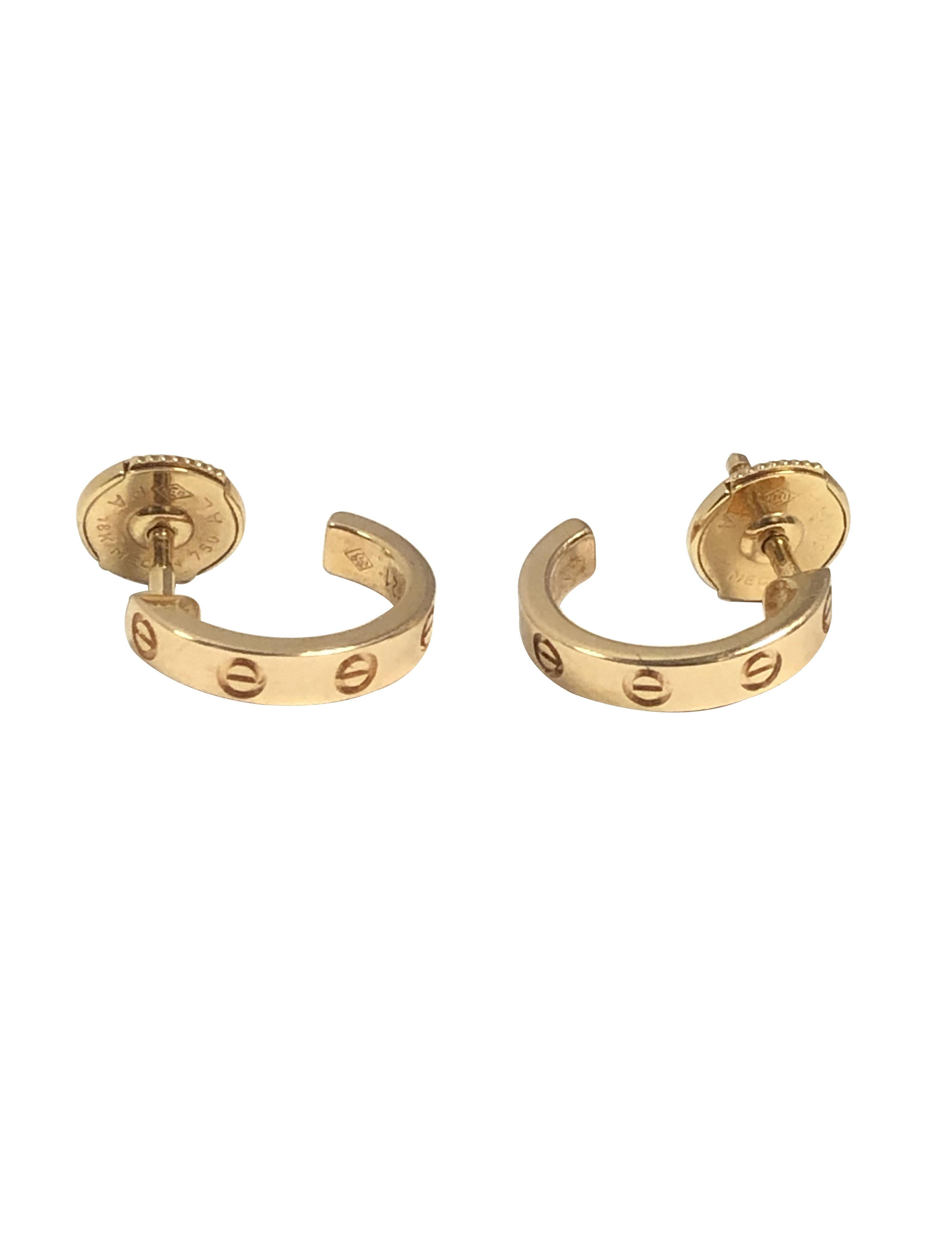 Circa 2015 Cartier Love Collection small 18K Yellow Gold half hoop, Hugge style earrings, measuring 1/2 inch in length and 2.5 M.M. Wide. Signed and Numbered, come in original Presentation box.