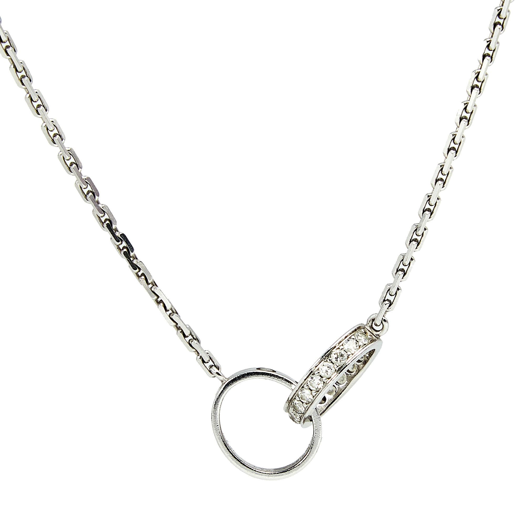 Celebrate timeless love with this necklace from Cartier's Love collection. It is made from 18k white gold and the chain holds two magnificent hoops interlocked with one another. One of the rings carries the iconic screw motifs—a signature of the