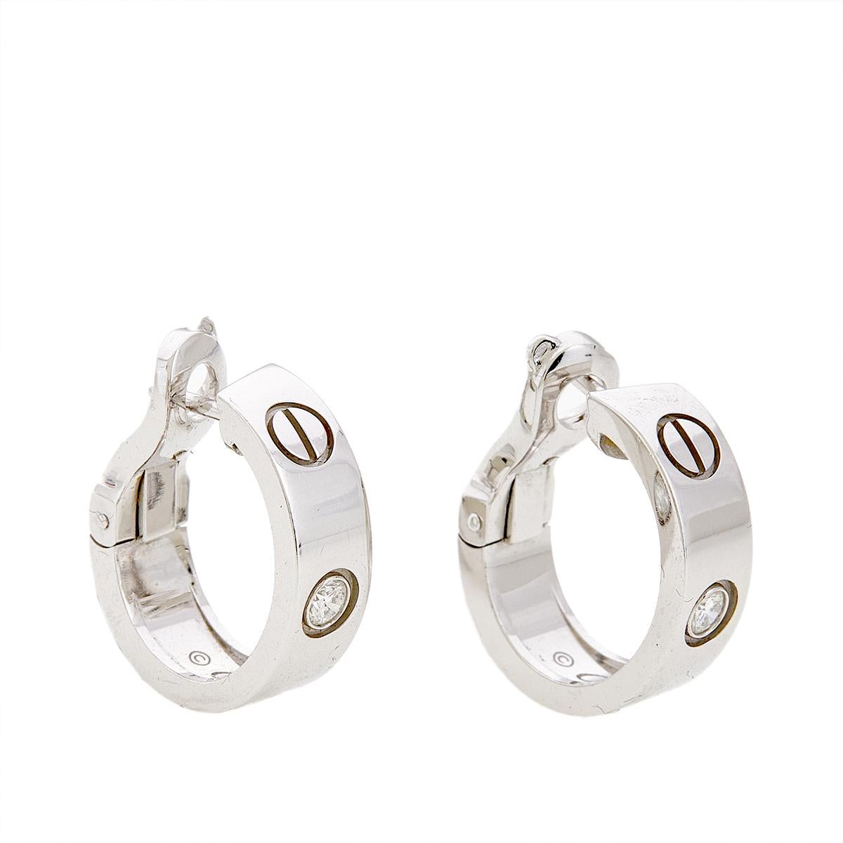 All one needs is a glance at these earrings to imagine how beautifully they'll sit on the ears. They come in a design of hoops sculpted from 18k white gold and detailed with the signature screw motifs as well as diamonds. They are not just easy to