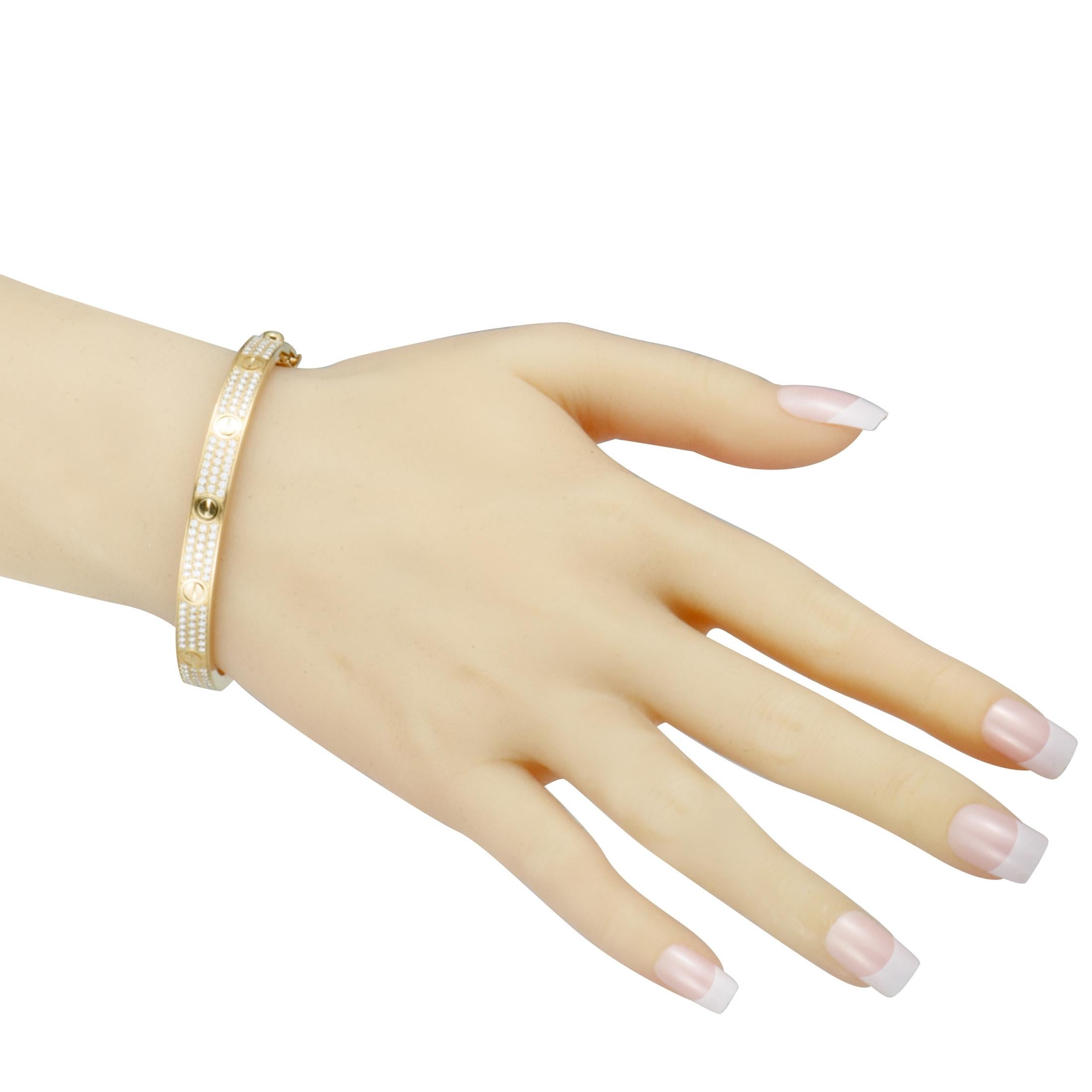 This sublime love bracelet by Cartier offers a look of utmost elegance. The gorgeous bracelet is expertly crafted from prestigious 18K yellow gold and is beautifully embellished with scintillating diamonds.
