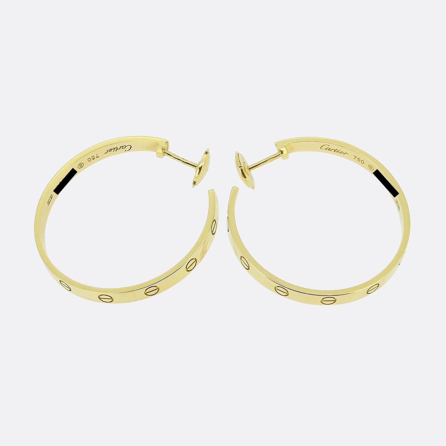 Here we have a wonderful pair of hooped earrings from the world renowned luxury jewellery house of Cartier. Collectively these identical pieces form part of their LOVE collection and have been crafted from 18ct yellow gold with the outer edge
