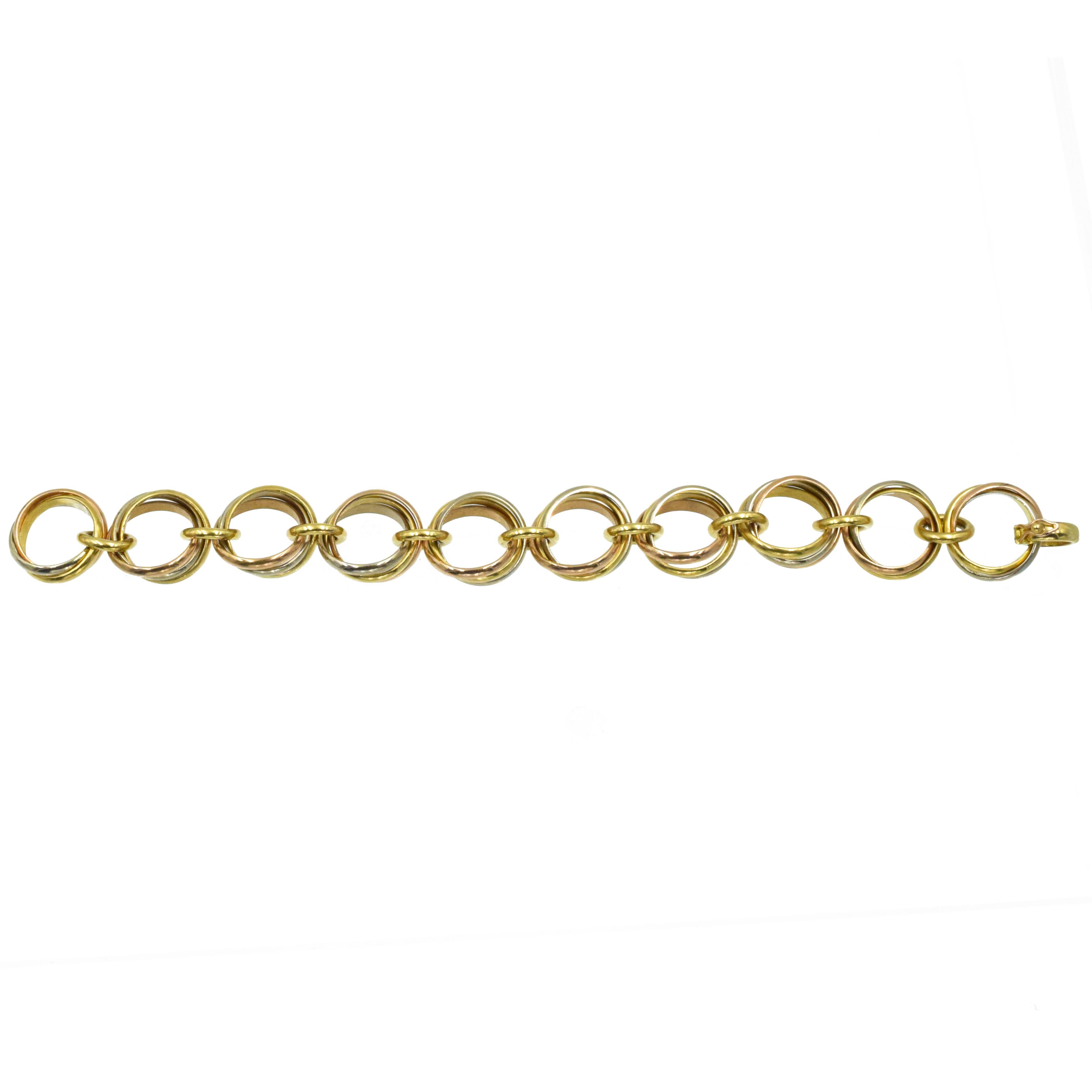 Cartier 'Trinity' Tri- Colored Link Bracelet. This bracelet has 10 'trinity' motif links made of 18k yellow, white, and pink gold connected by 18k yellow gold circular links and clasps with security lock. Signed Cartier, 1991, Serial No. B49693.