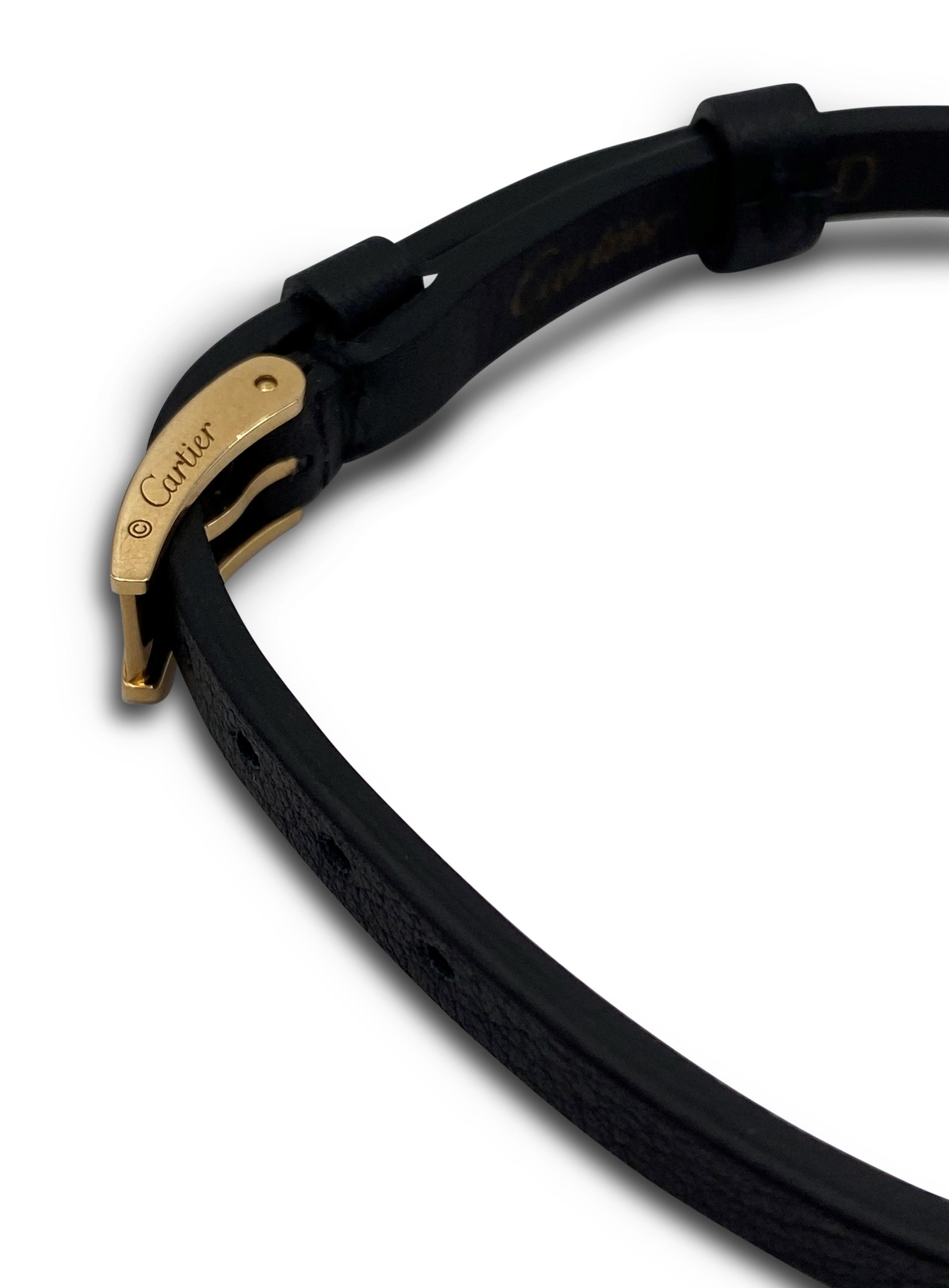 Authentic Cartier 'Love' slide bar bracelet. The bar is crafted in 18 karat yellow gold featuring a long rectangular shape bar with 3 screw motifs which slides on the slim (6mm width) black leather strap with 18 karat yellow gold buckle. Bracelet is