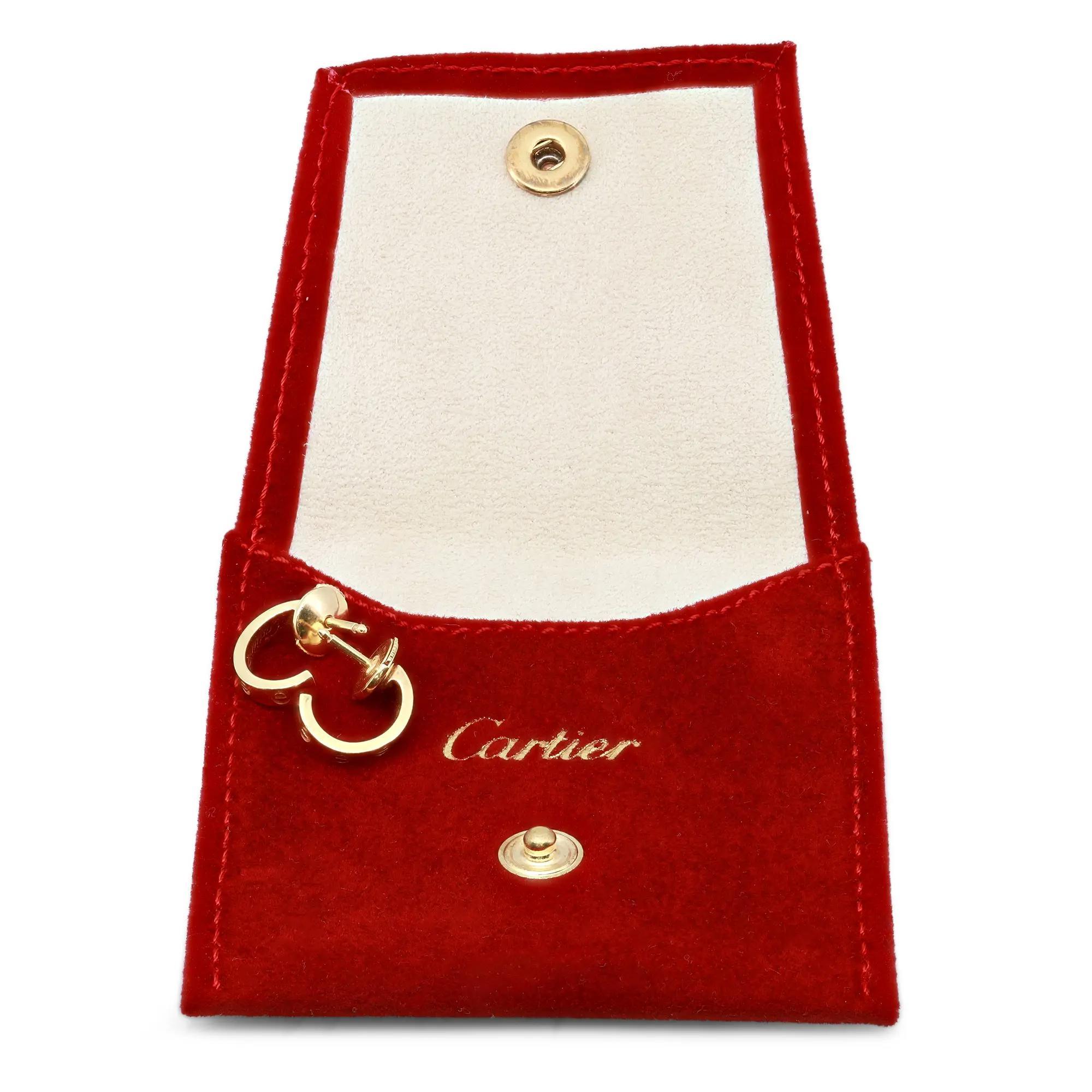Beautiful Cartier love hoop earrings crafted in 18k yellow gold featuring screw motif in an oval shape hoops. Width: 2.65mm. Inner Diameter: 10mm. Comes with push back post. Total weight: 3.40 grams. Excellent preowned condition. Original box and