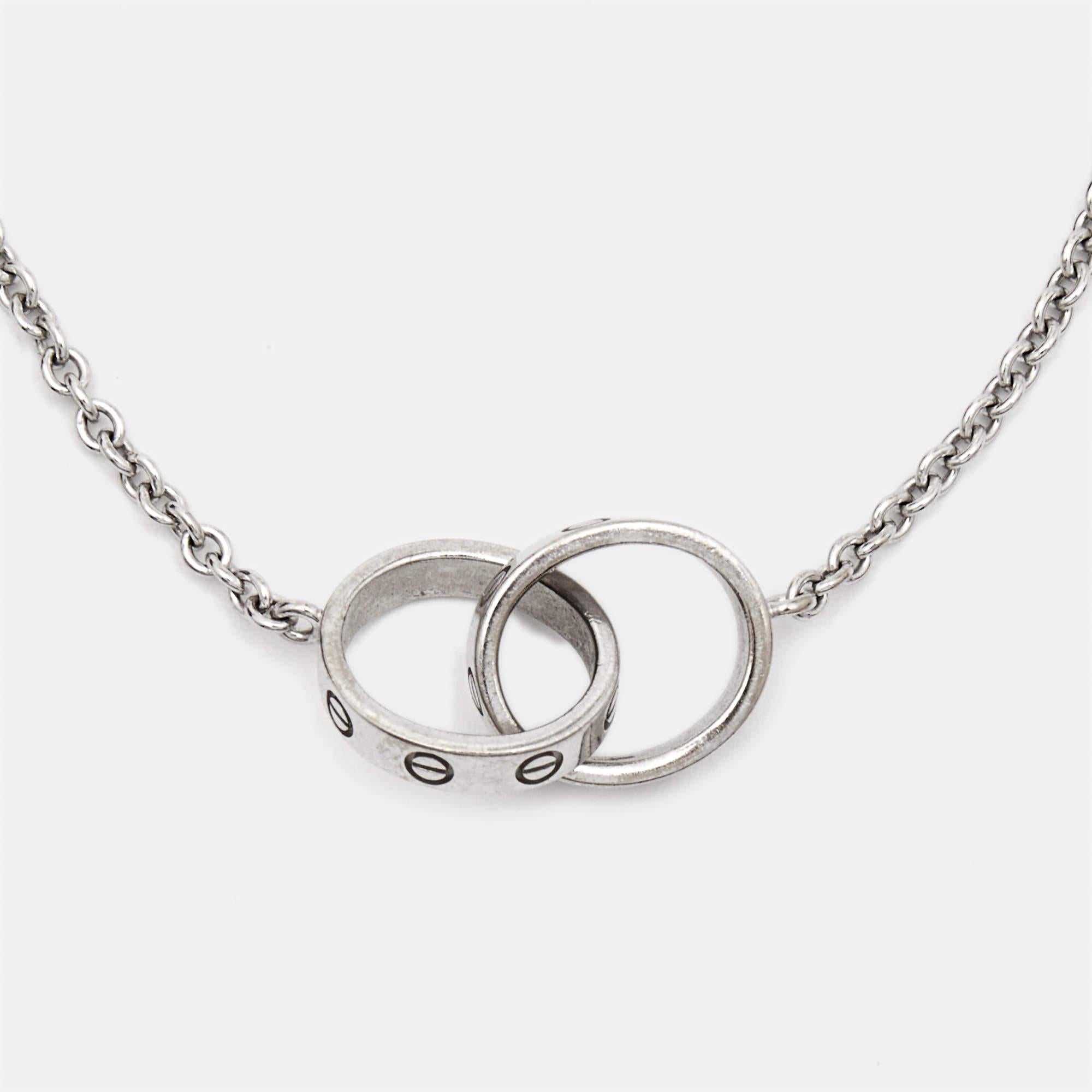 Celebrate timeless love with this bracelet from Cartier's Love collection. It is sculpted from 18k white gold, and the chain holds two magnificent hoops interlocked with one another. Both the rings carry the iconic screw motifs—a signature of the